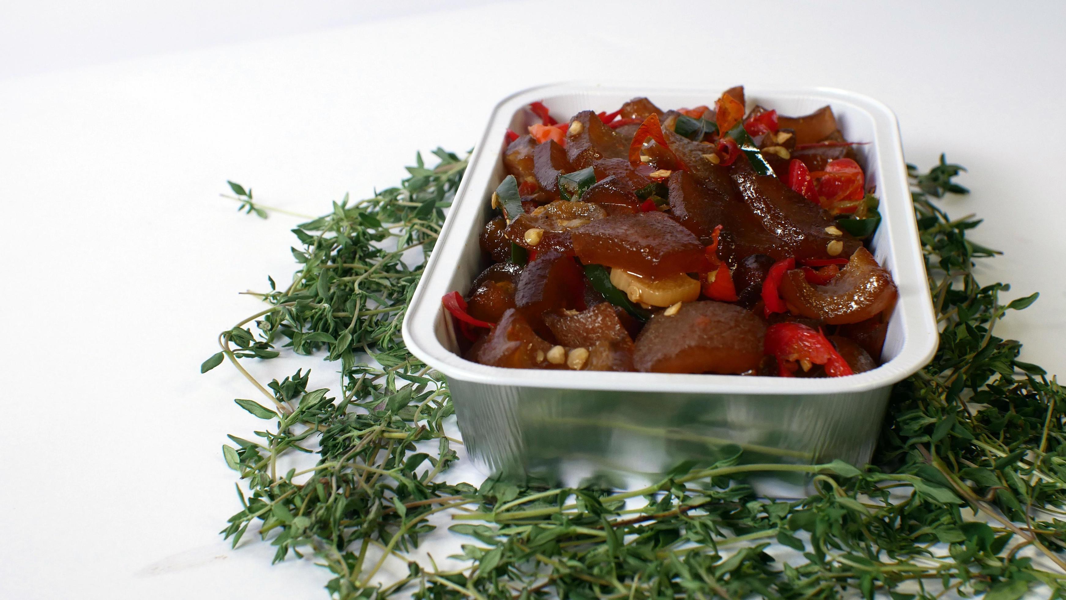 Stir-fried beef skin served in an aluminum place with typical Indonesian food on a white background Stock Free