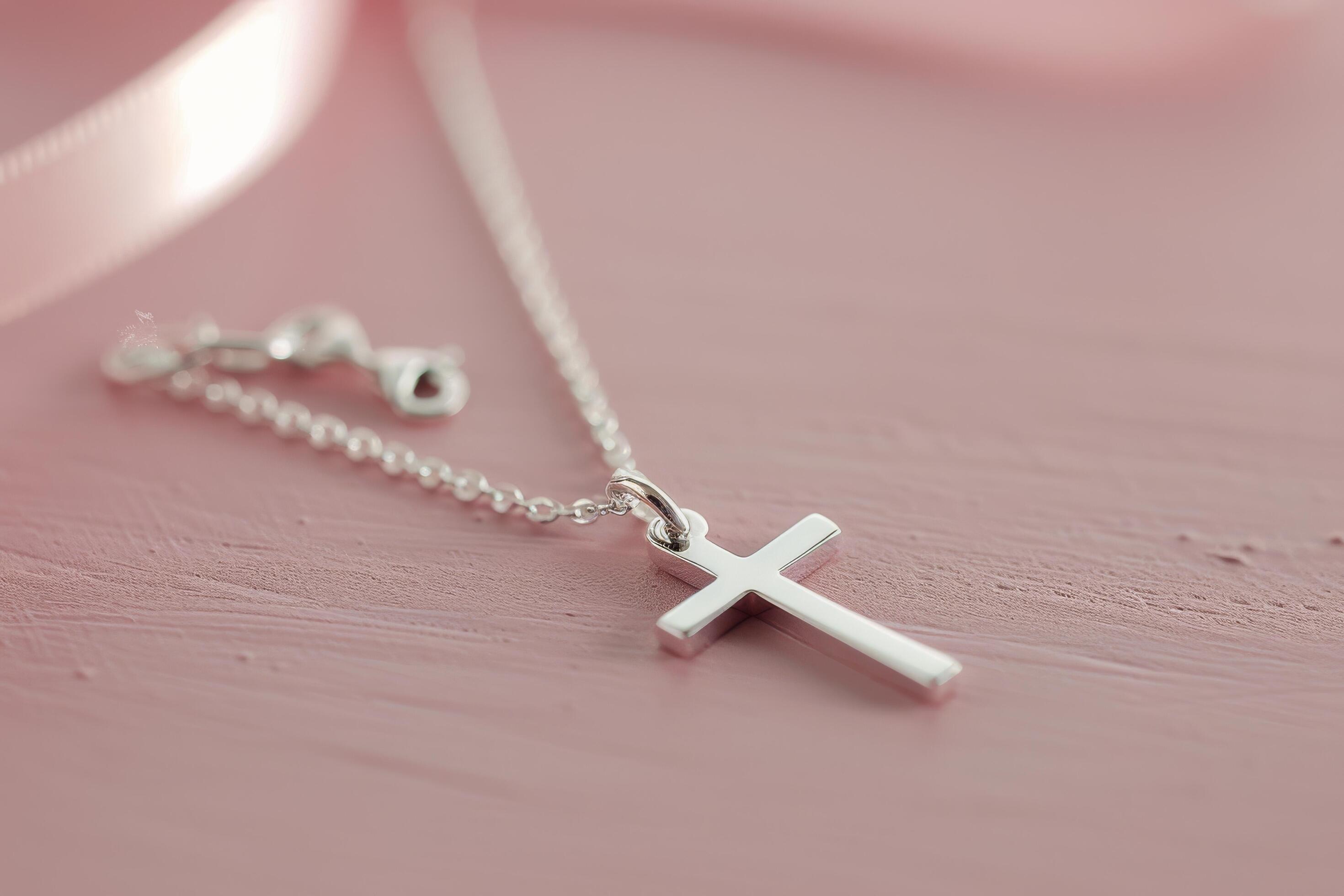 
									Silver Cross Necklace on Pink Background Stock Free