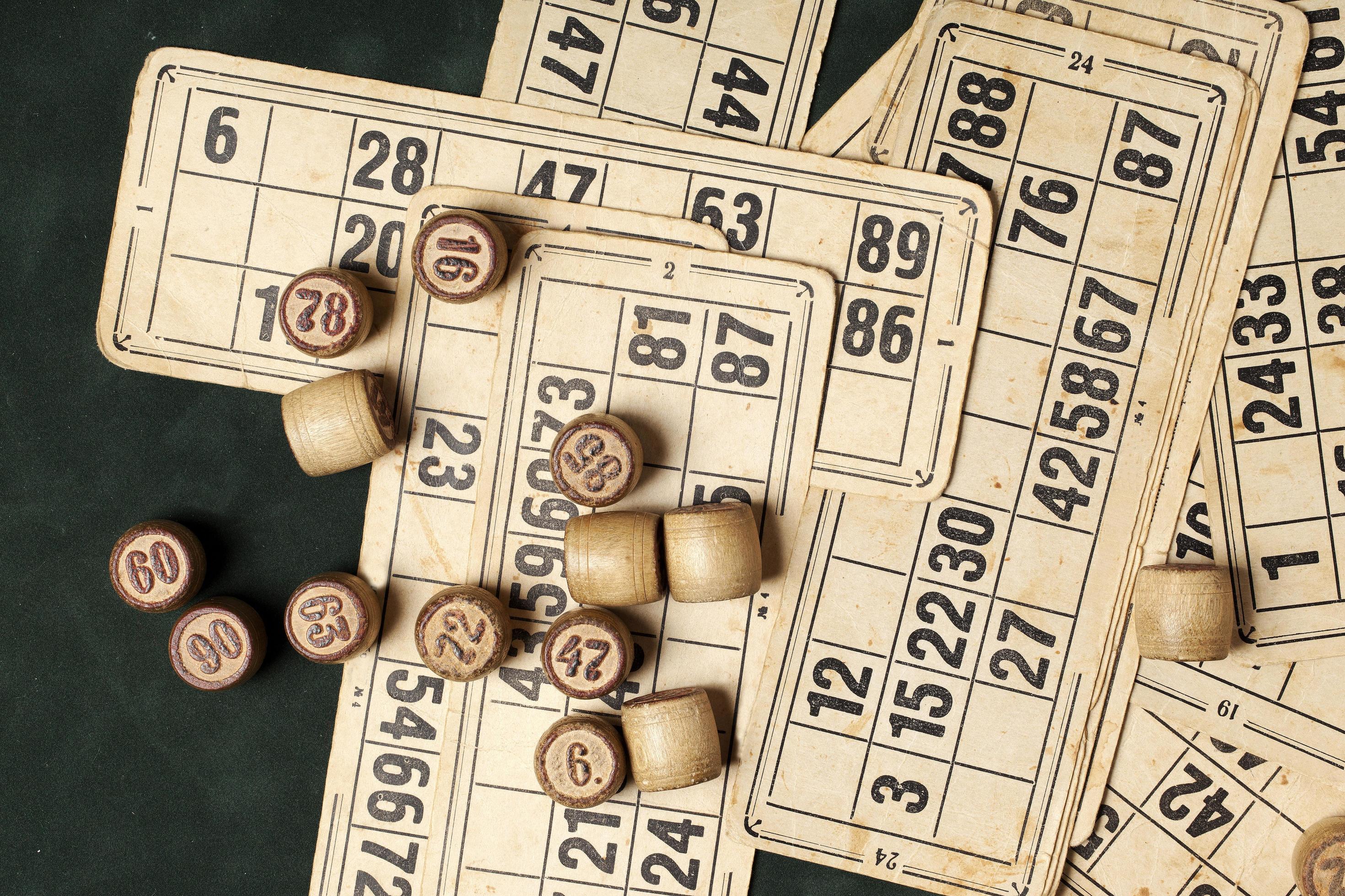 Table game Bingo. Wooden Lotto barrels with bag, playing cards for Lotto games, games for family. Stock Free