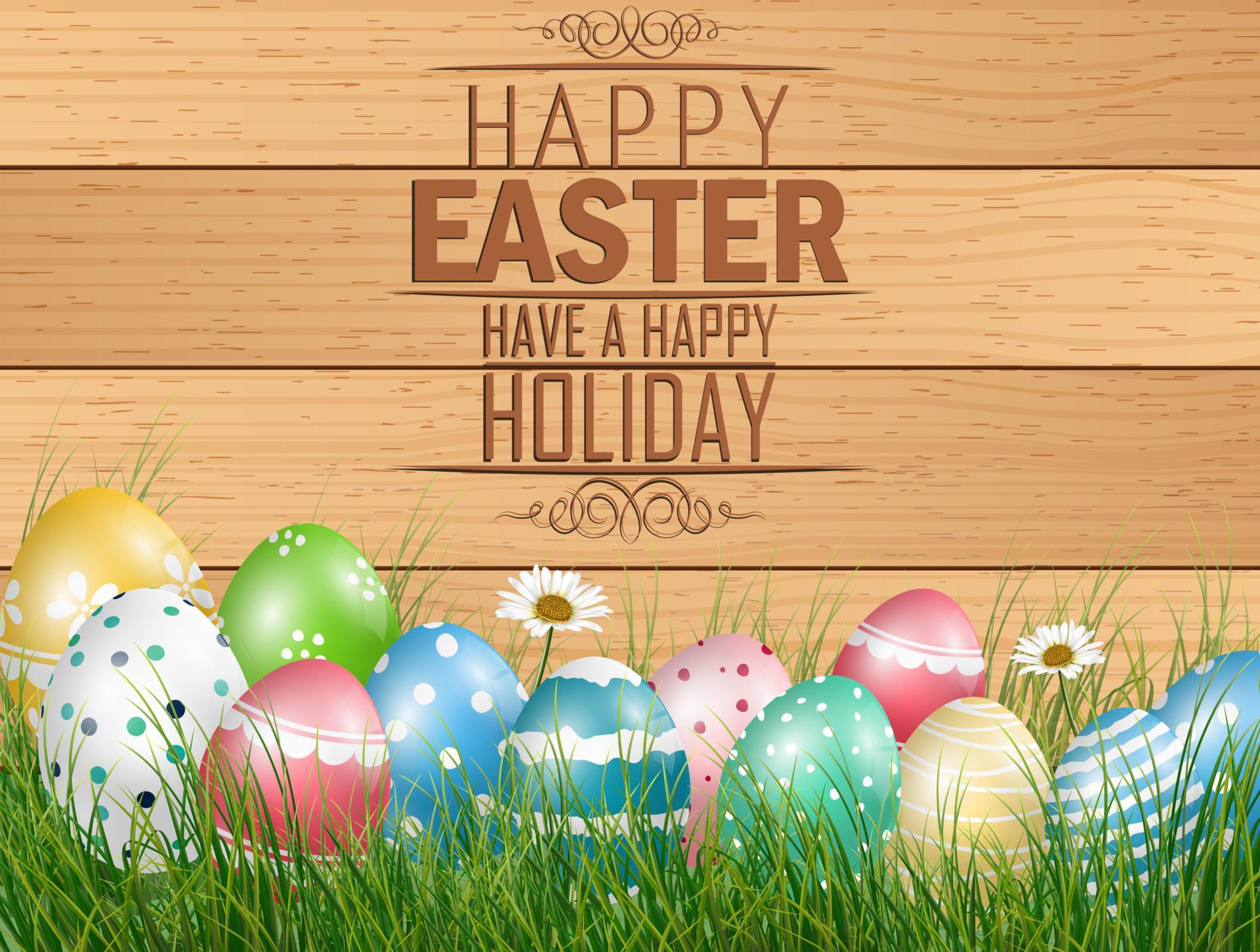 Happy Easter background with colored eggs on grass with flower on wooden background Stock Free