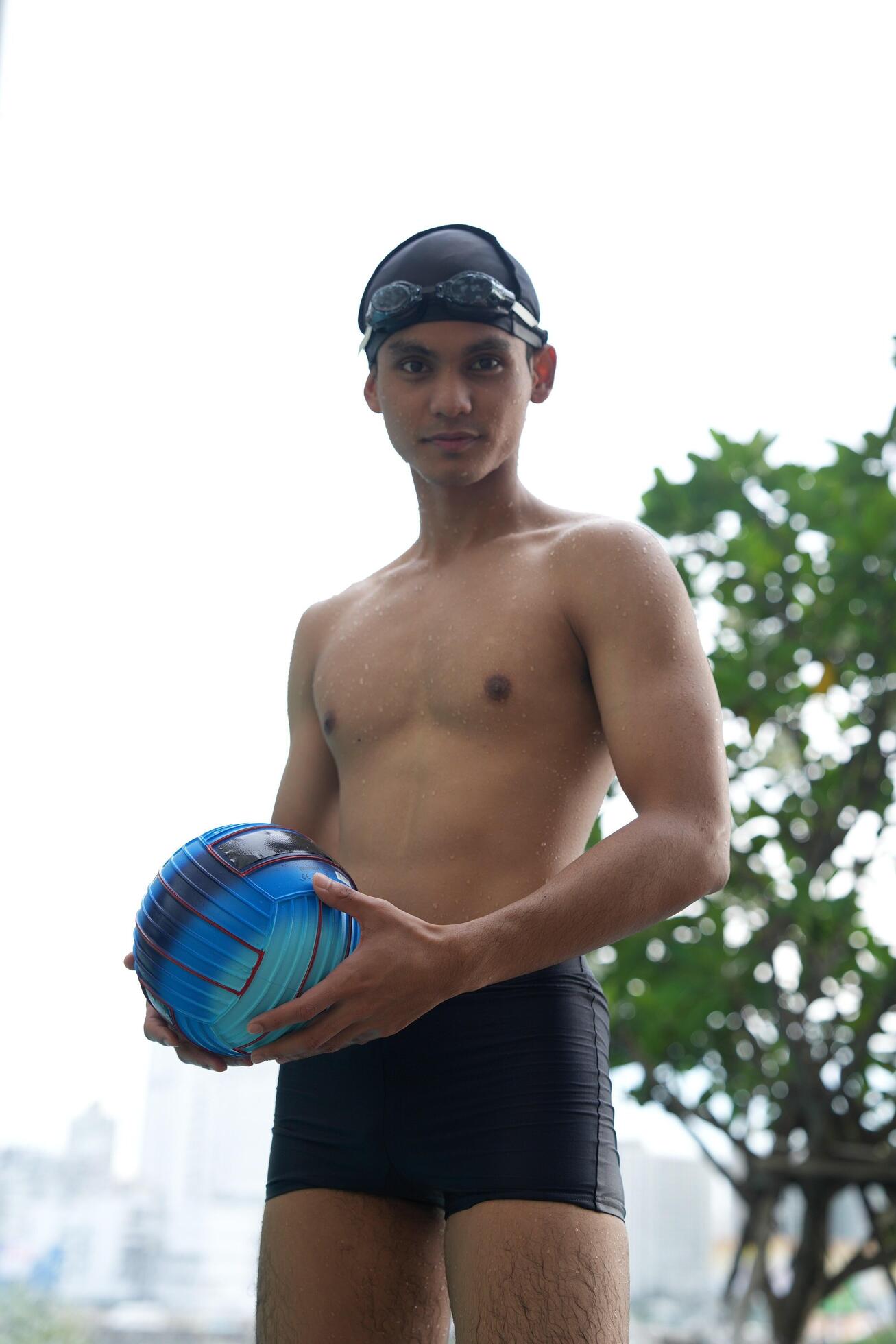 Asian men practicing swimming and preparing to play water polo and stretching and resting for water sports. Stock Free