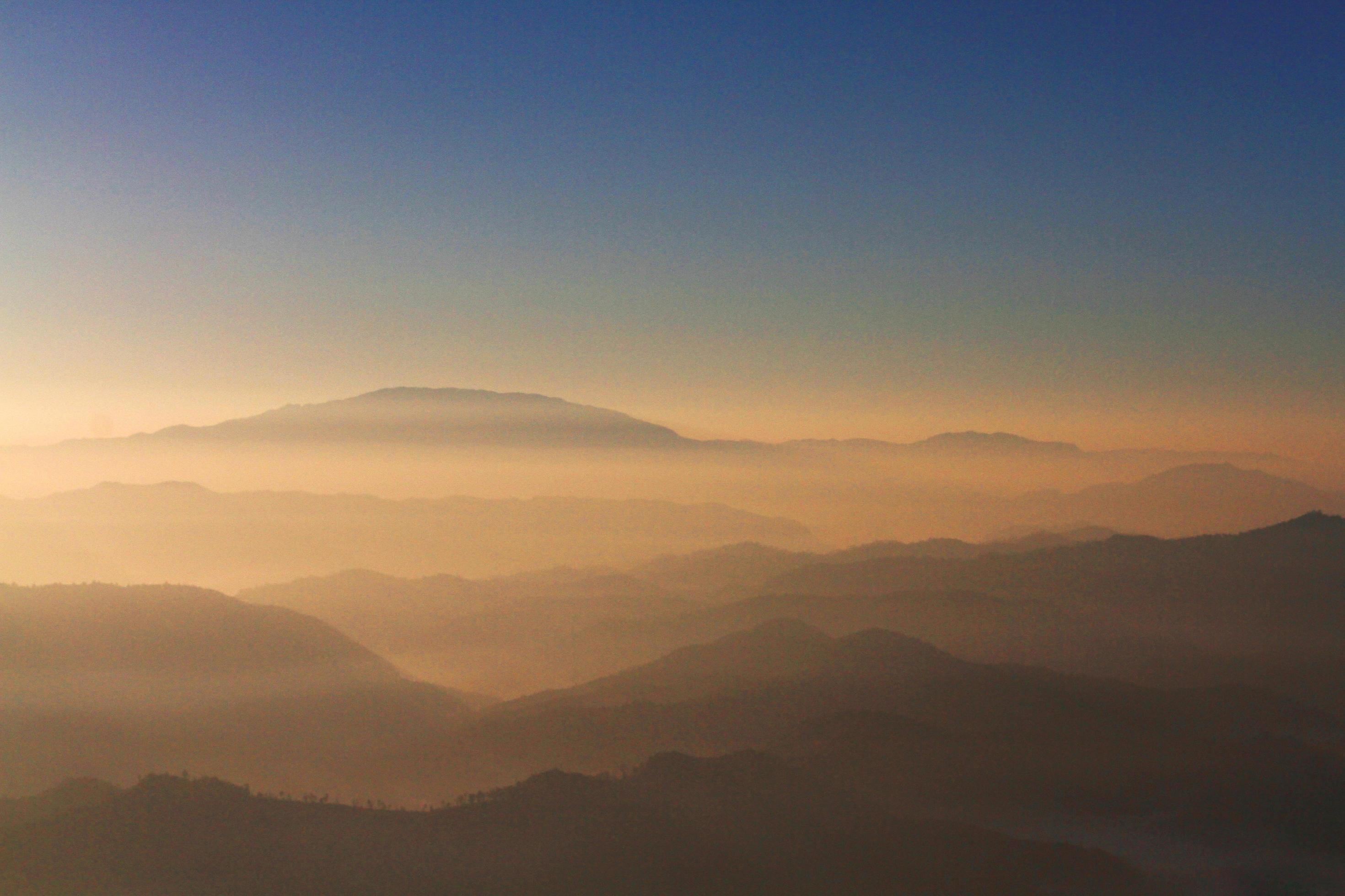 Beautiful Sunset and sunrise on sky and golden twilight time with mist and fog in valley of mountain layer Stock Free