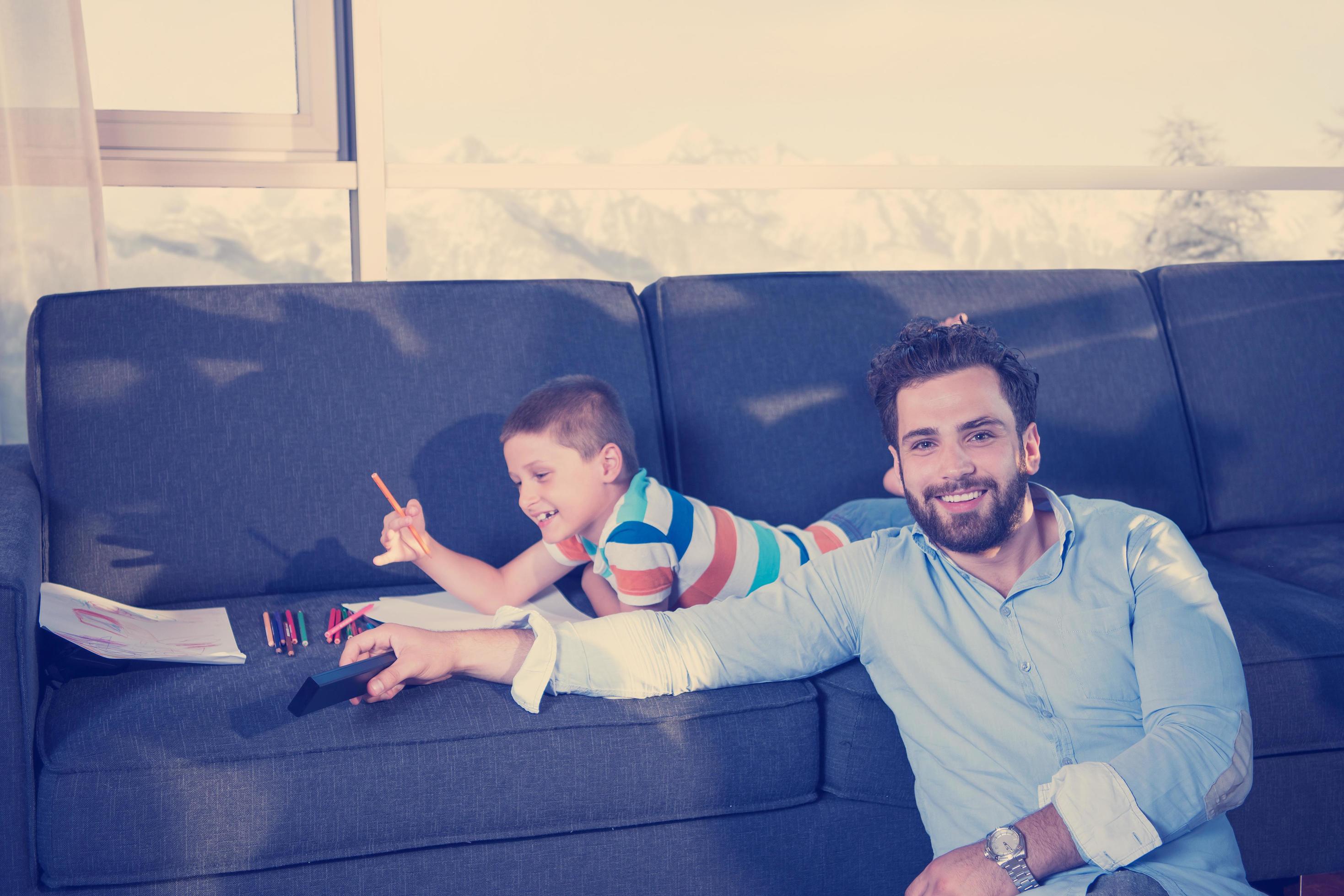 Happy Young Family Playing Together on sofa Stock Free