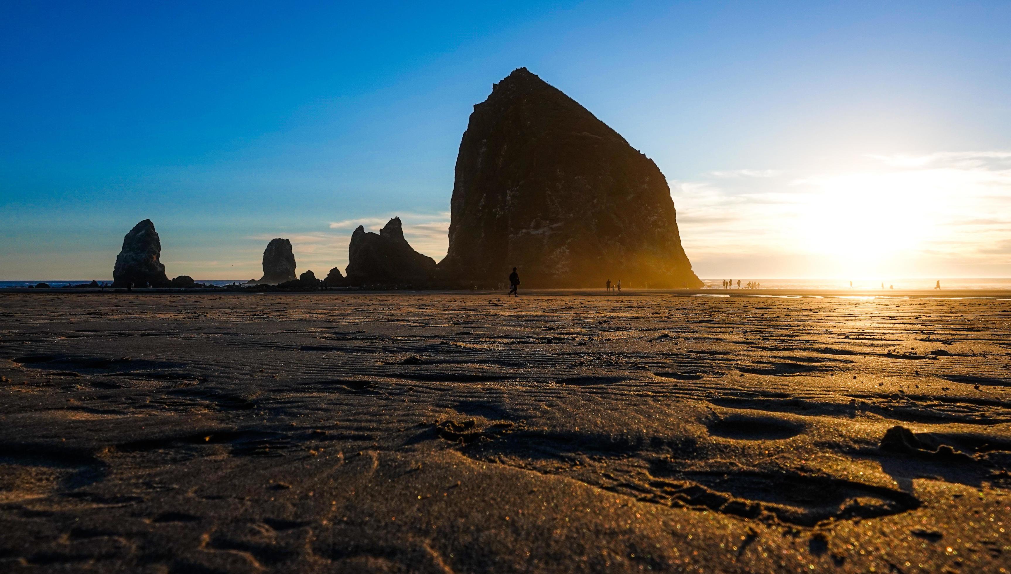 A golden sunset behind the beautiful Haystack Rock in Cannon Beach, Oregon. Stock Free