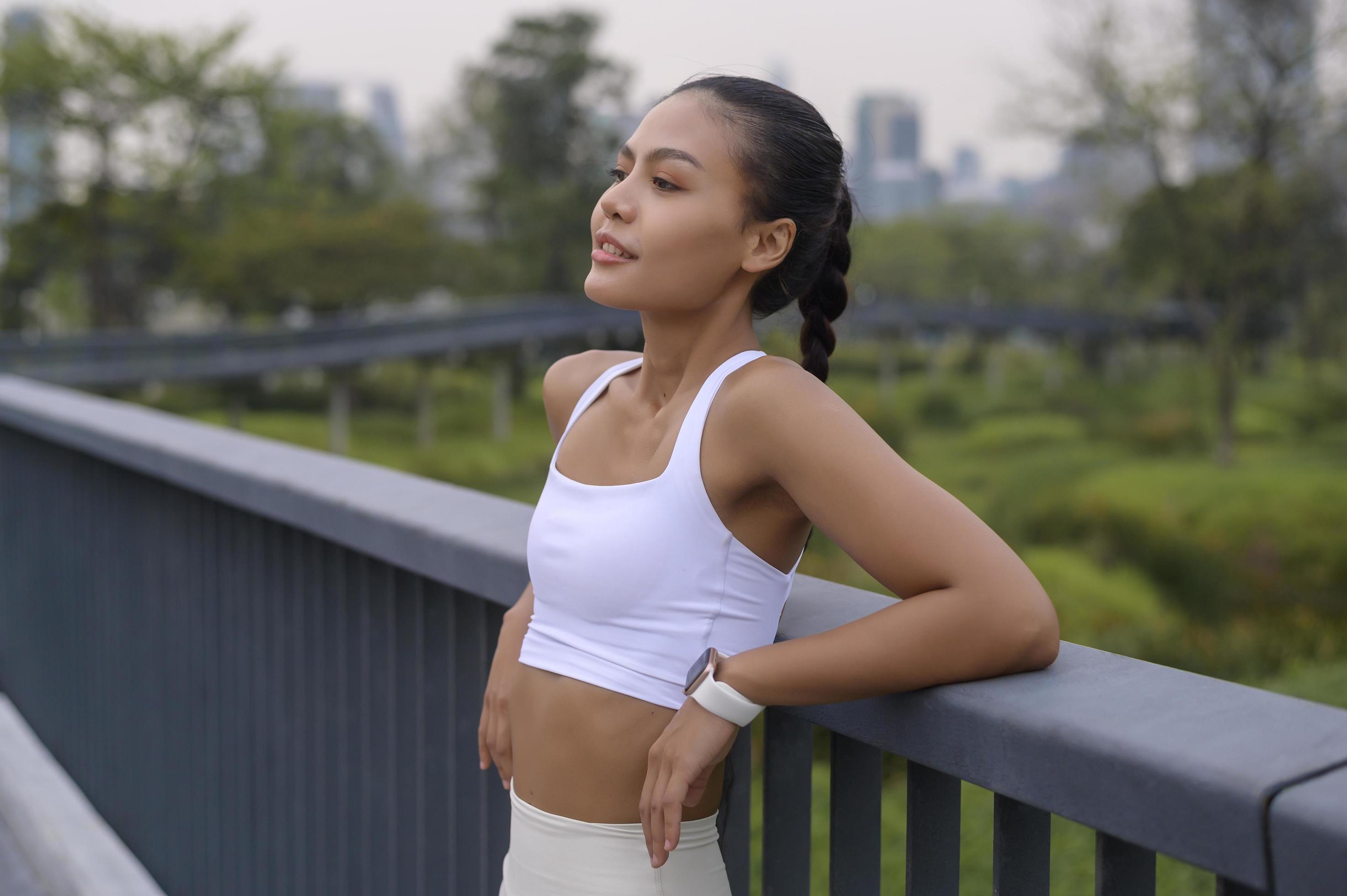 Portrait of young fitness woman in sportswear in city park, Healthy and Lifestyles. Stock Free