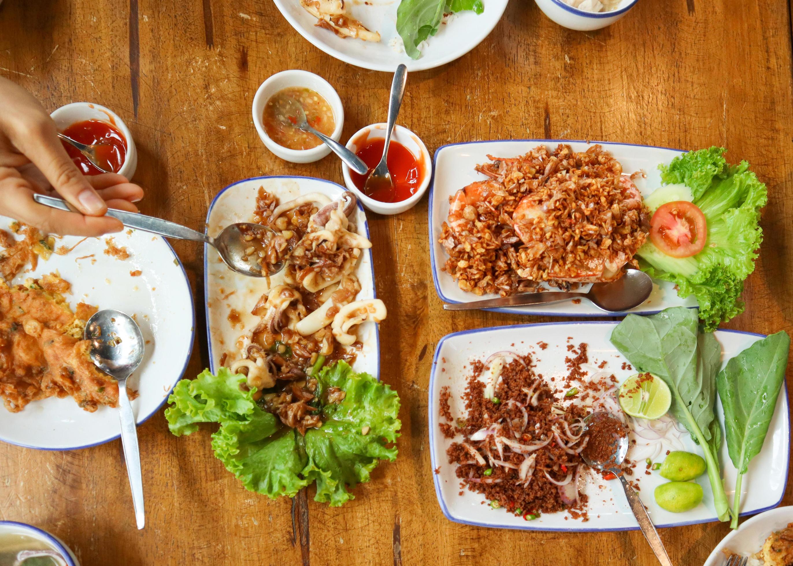 Family lunch food on wooden table with all local food eat with Thai steamed rice. Stock Free