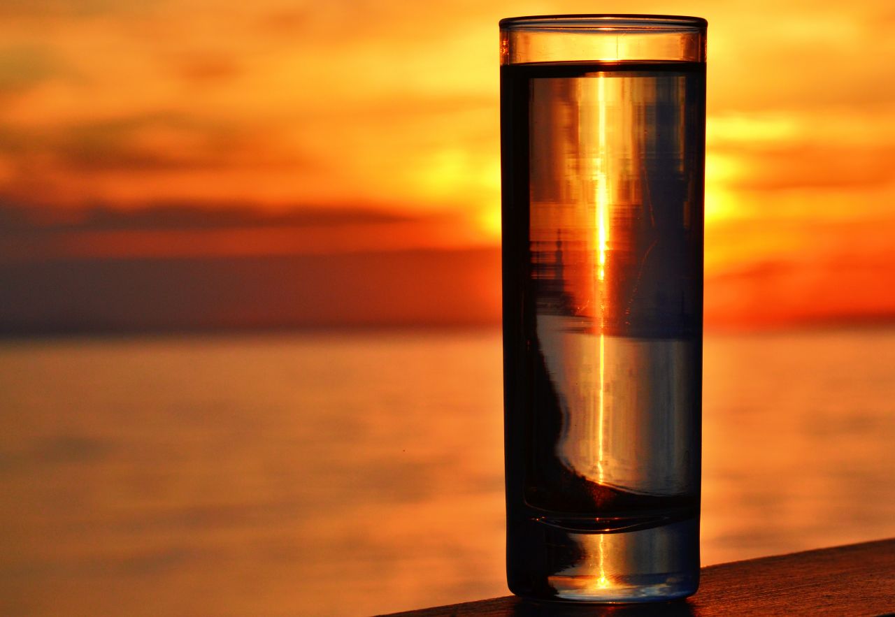 Water Glass by the Sea with Sunset Background Stock Free