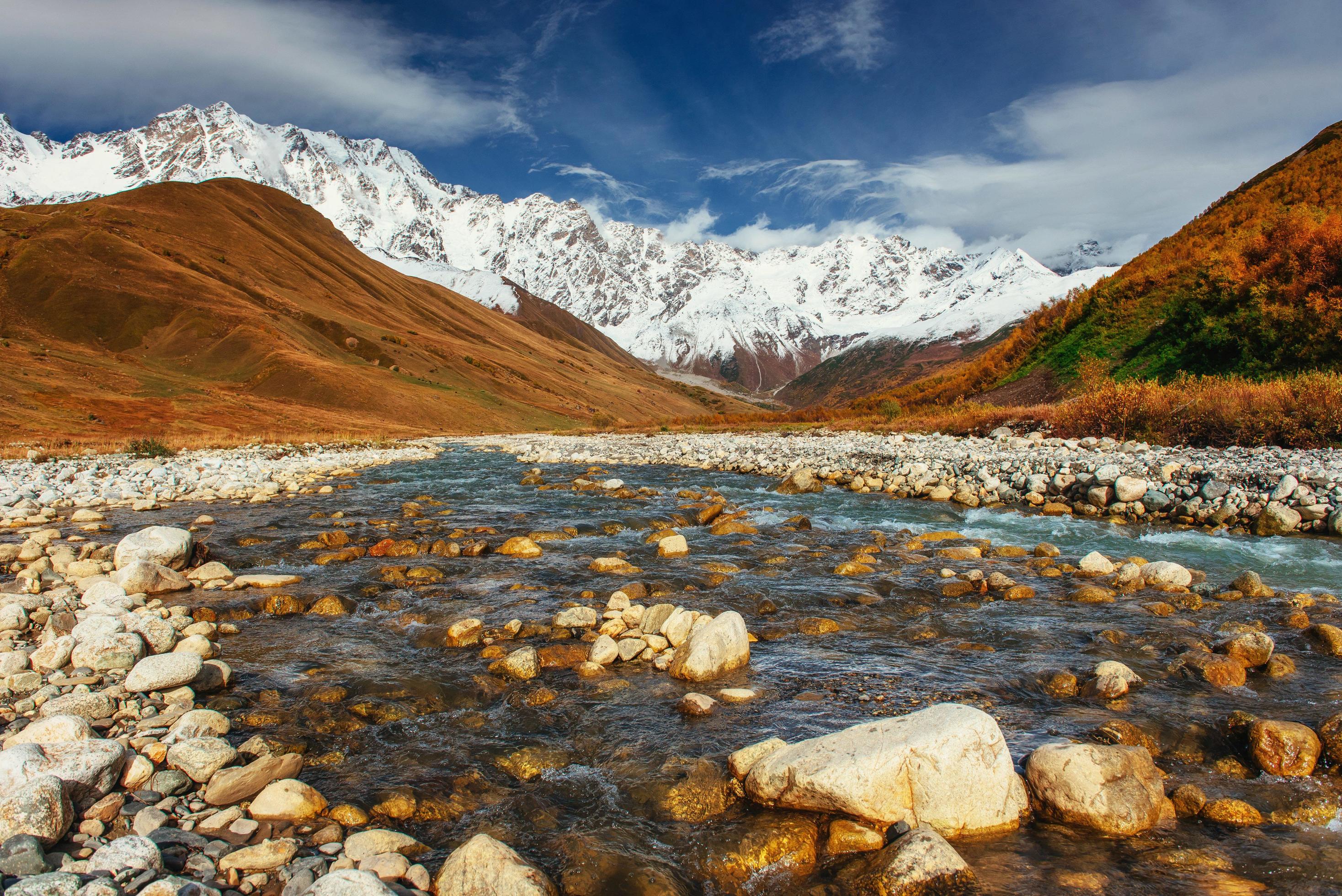 Snowy mountains and noisy mountain river. Georgia, Svaneti Stock Free