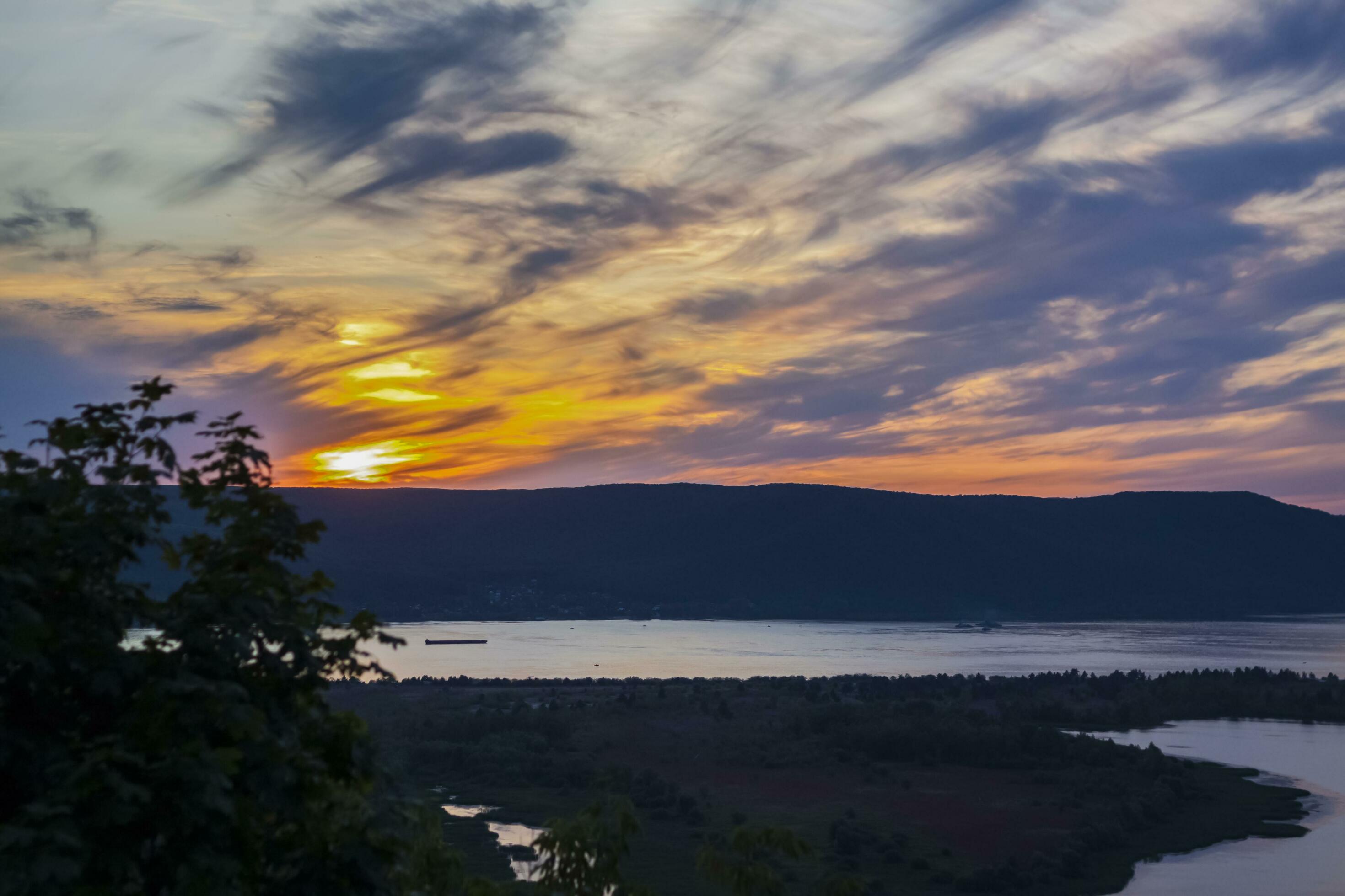 sunset on the Volga river. Natural landscape. reflection, blue sky and yellow sunlight. landscape during sunset. Stock Free