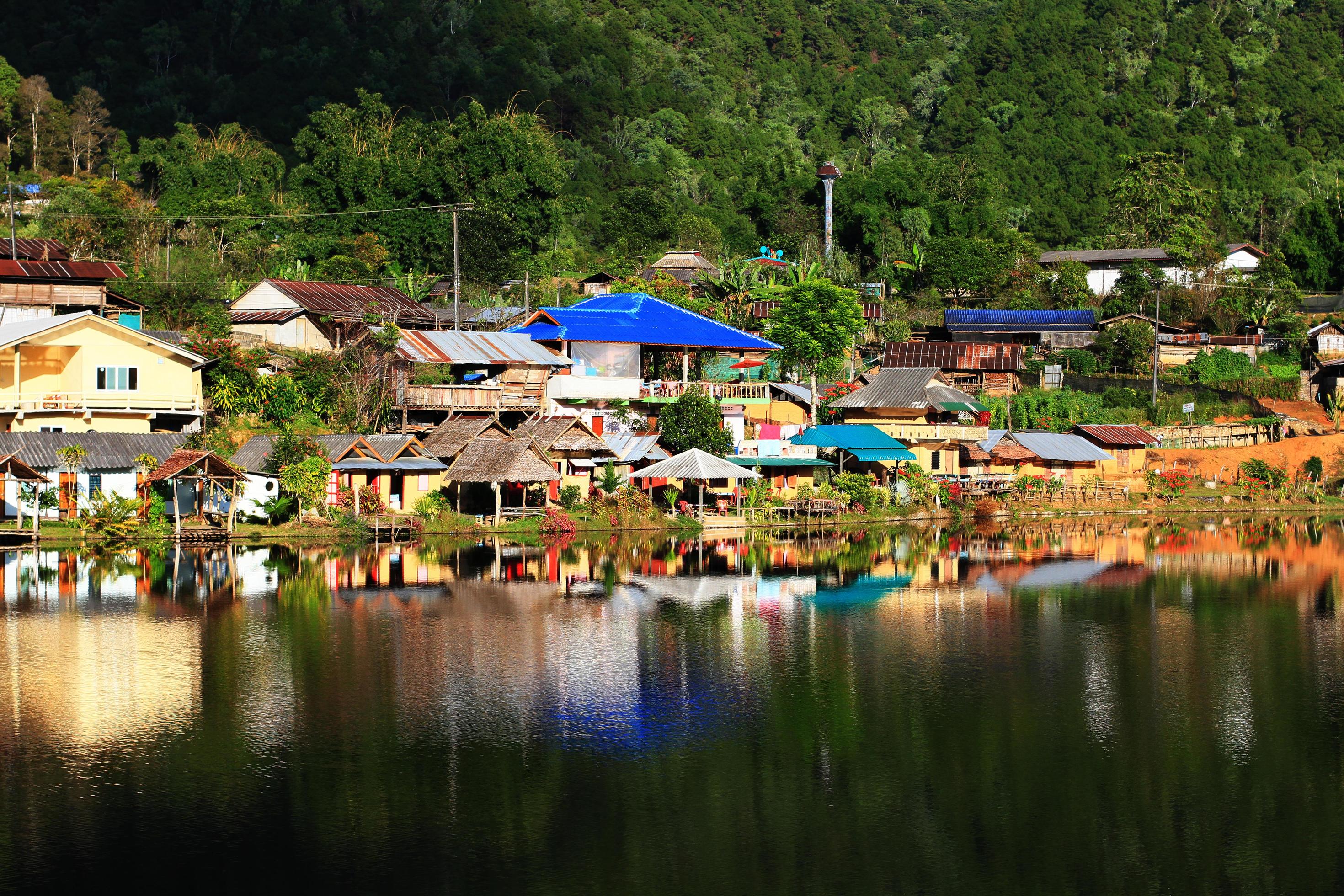 Beautiful landscape village on mountain and blue sky reflection in lake and river at Meahongson province, Thailand Stock Free