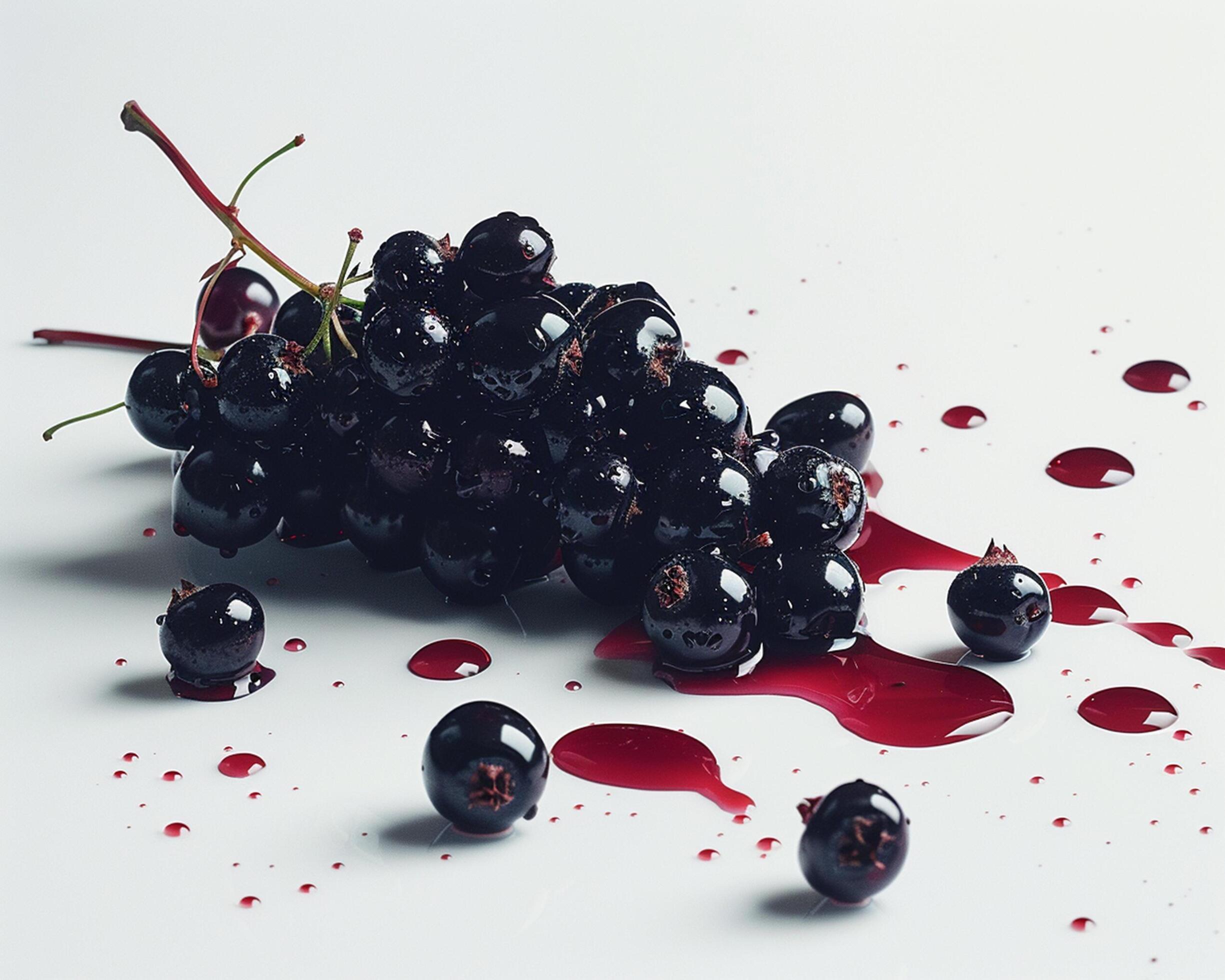 a bunch of black currants on a white surface Stock Free