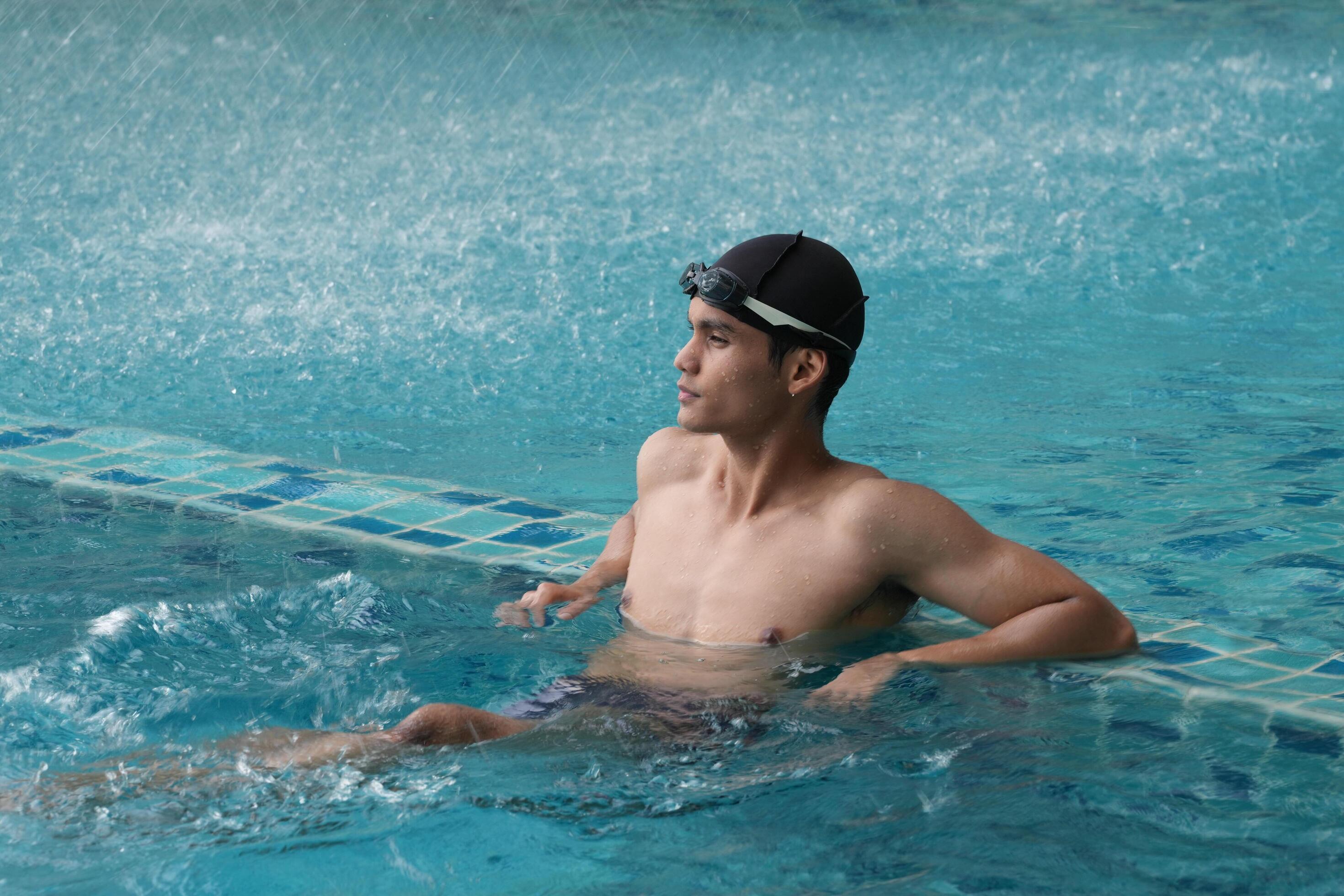 Asian men practicing swimming and preparing to play water polo and stretching and resting for water sports. Stock Free