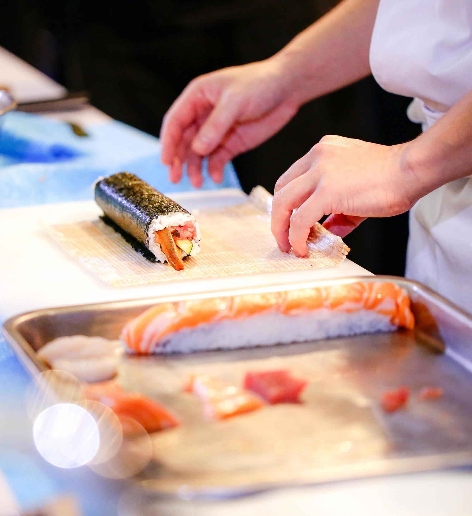 chef hands preparing japanese food, chef making sushi Stock Free