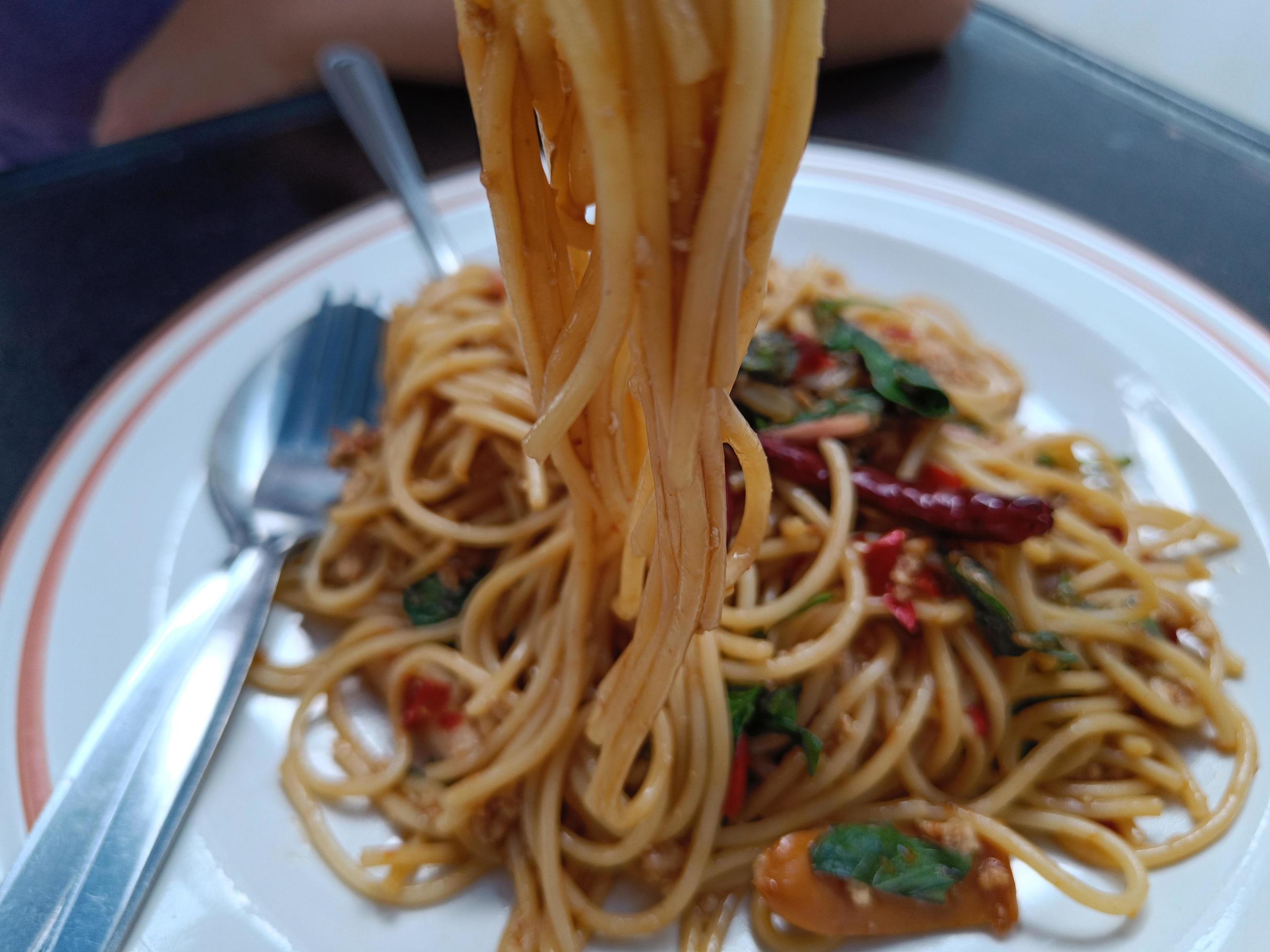 selective focus spaghetti with Spicy pork, sausage and basil.Thai fusion food Stock Free