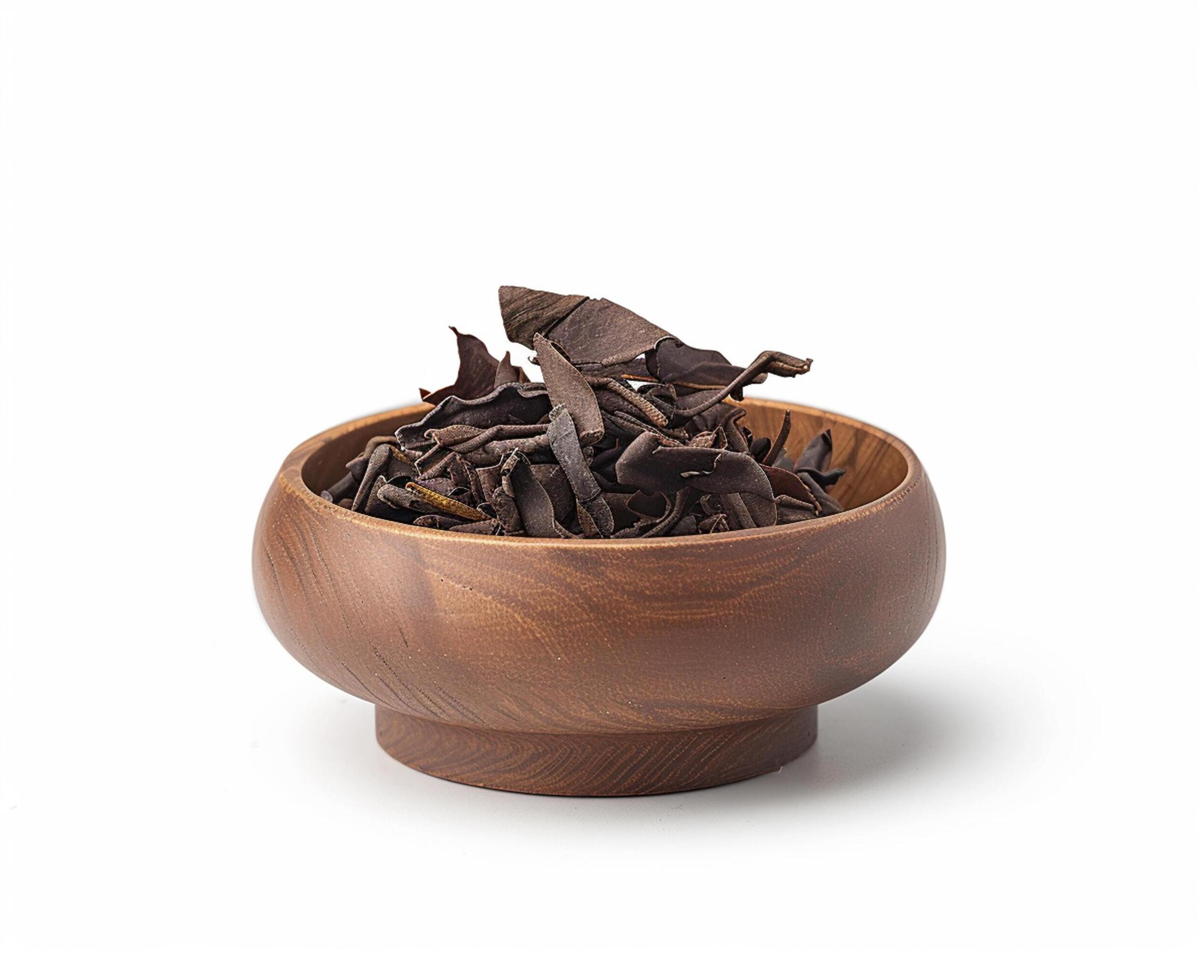 a wooden bowl filled with dried leaves Stock Free