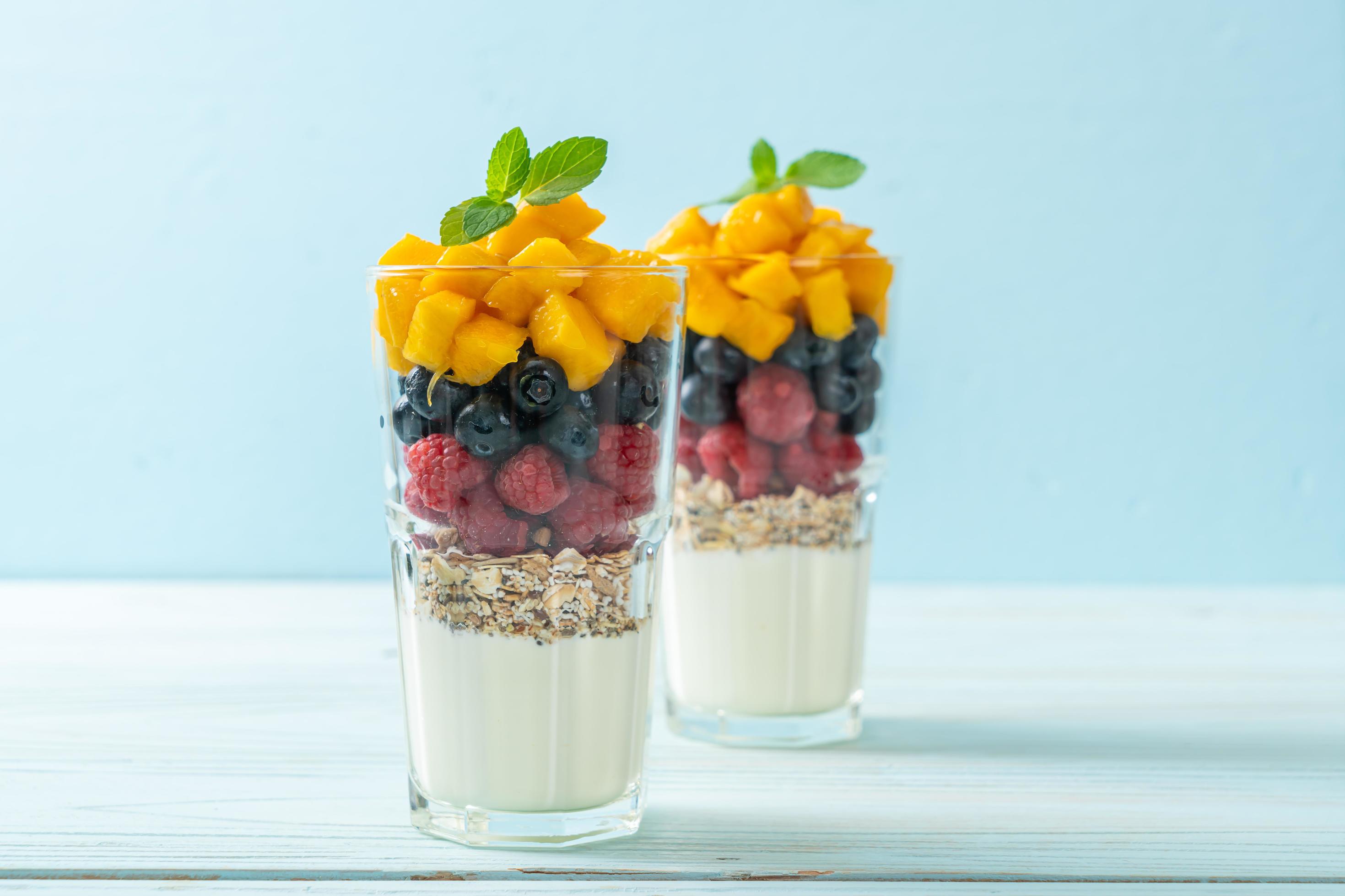 Homemade mango, raspberry, and blueberry with yogurt and granola – healthy food style Stock Free