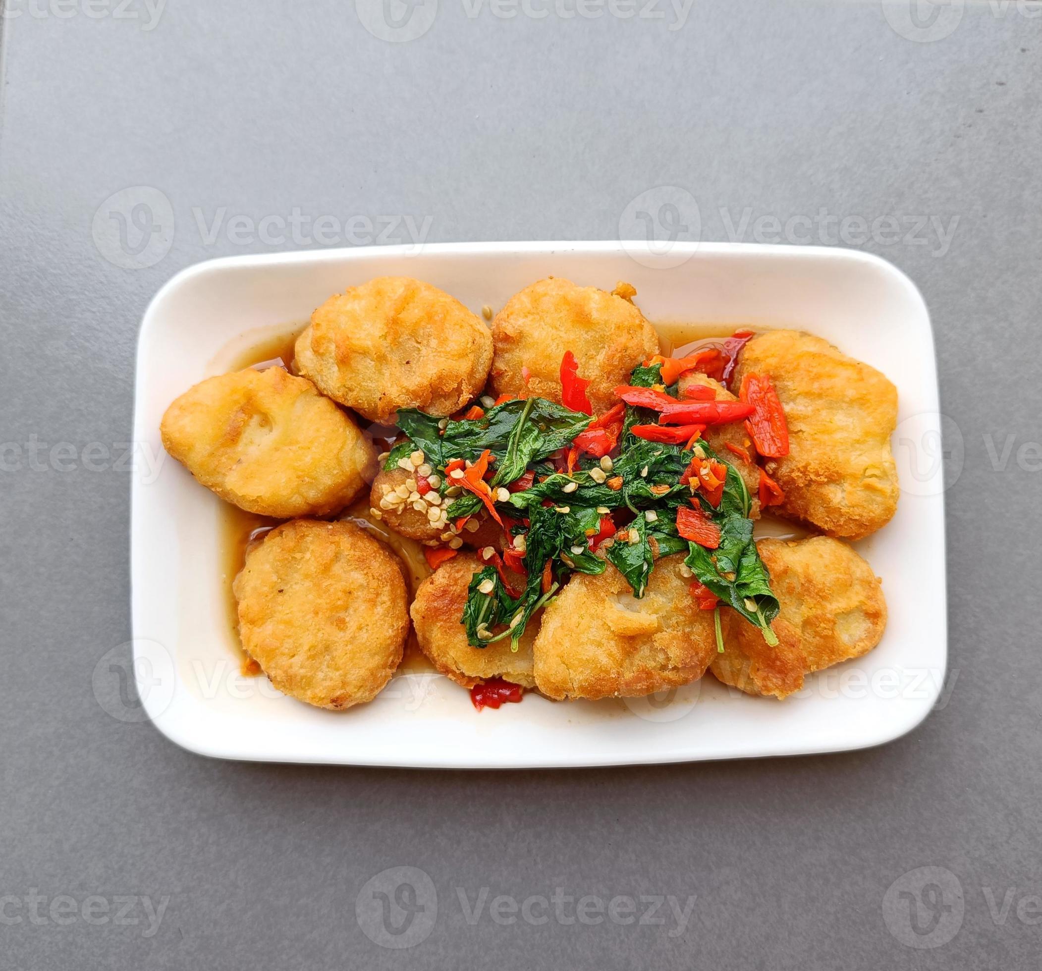 Hot and spicy basil nuggets on a white plate, fusion Thai food Stock Free