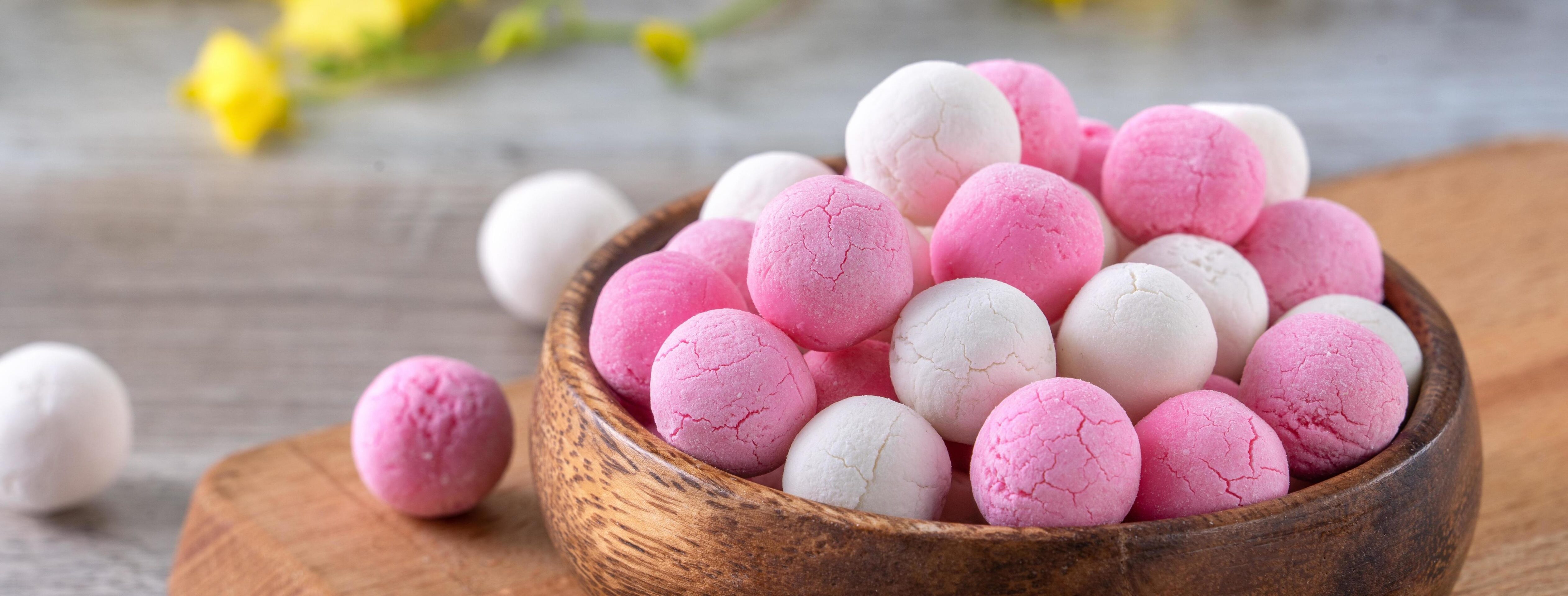 Raw red and white tangyuan on wooden table background for Winter solstice food. Stock Free