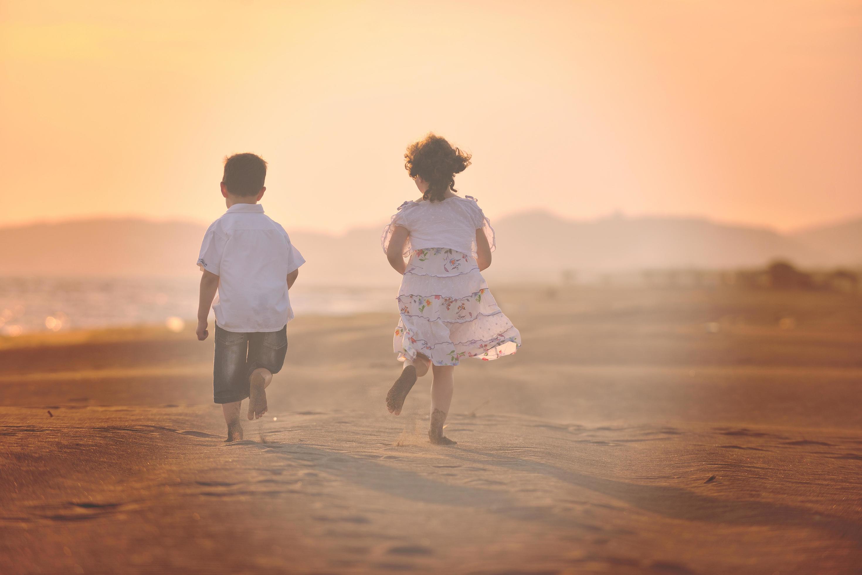 happy young family have fun on beach at sunset Stock Free