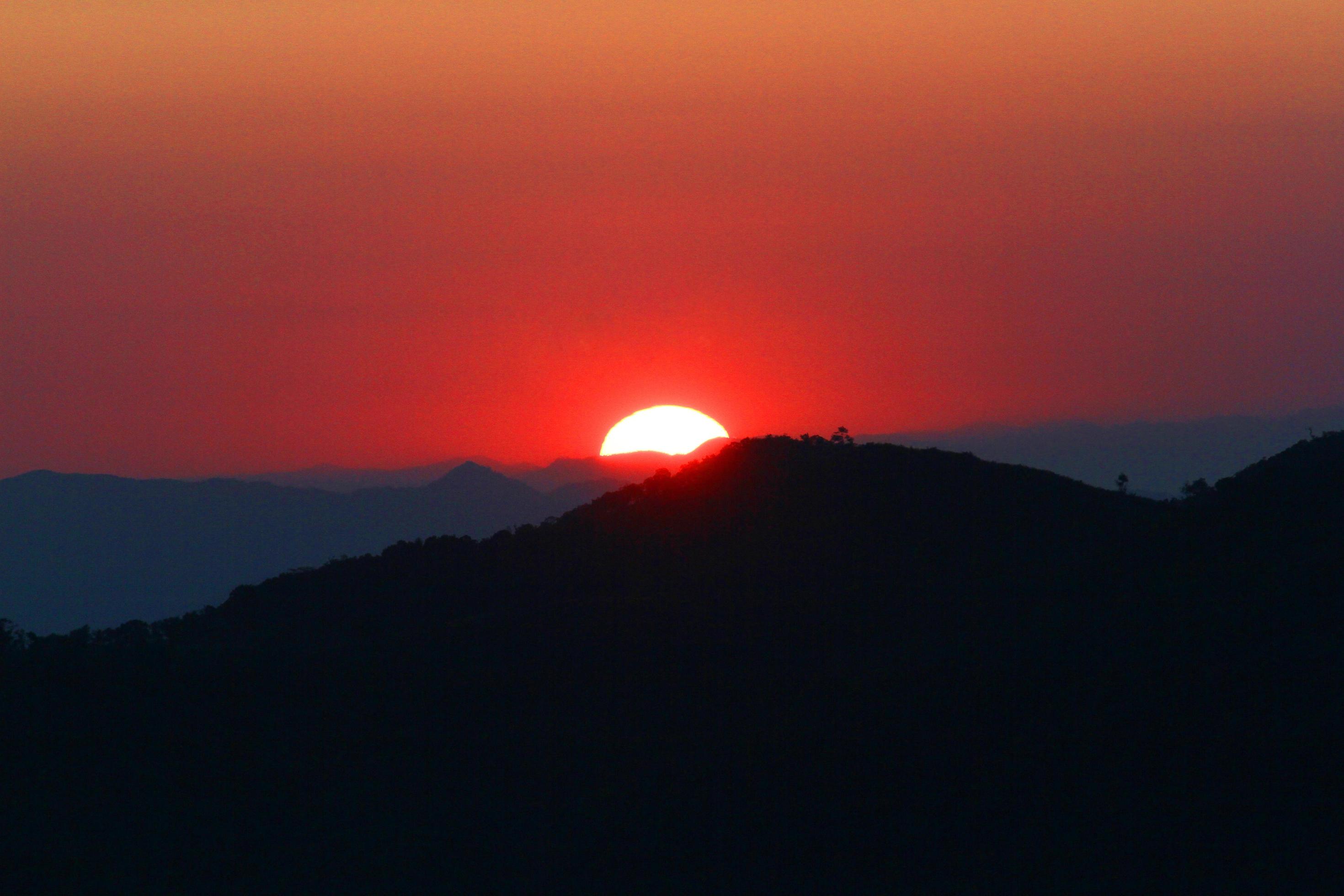 Sunset in sky and cloud, beautiful colorful twilight time with silhouette of mountain. Stock Free