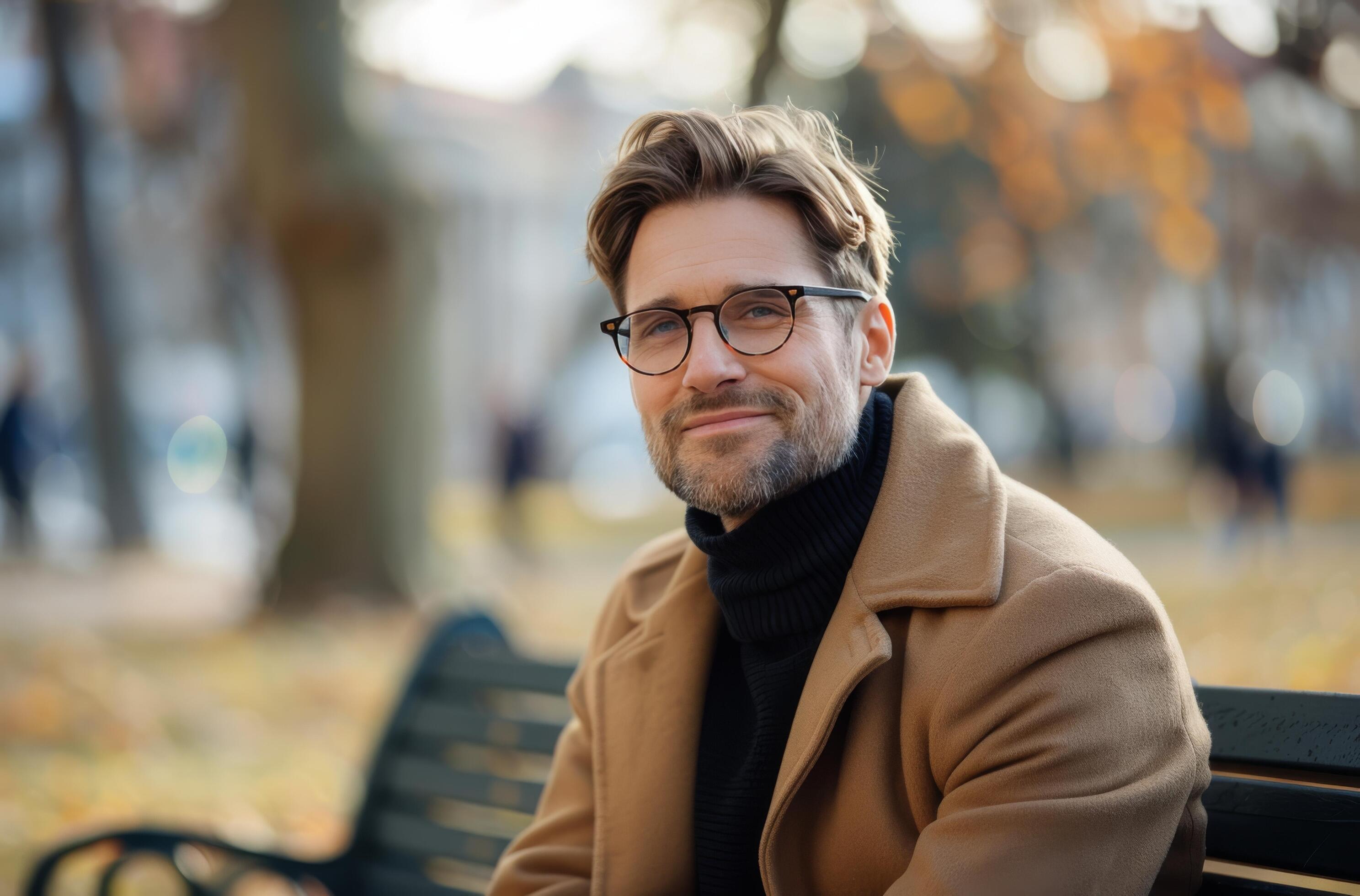 Smiling Man In Brown Coat Sitting On A Bench On An Autumn Day Stock Free