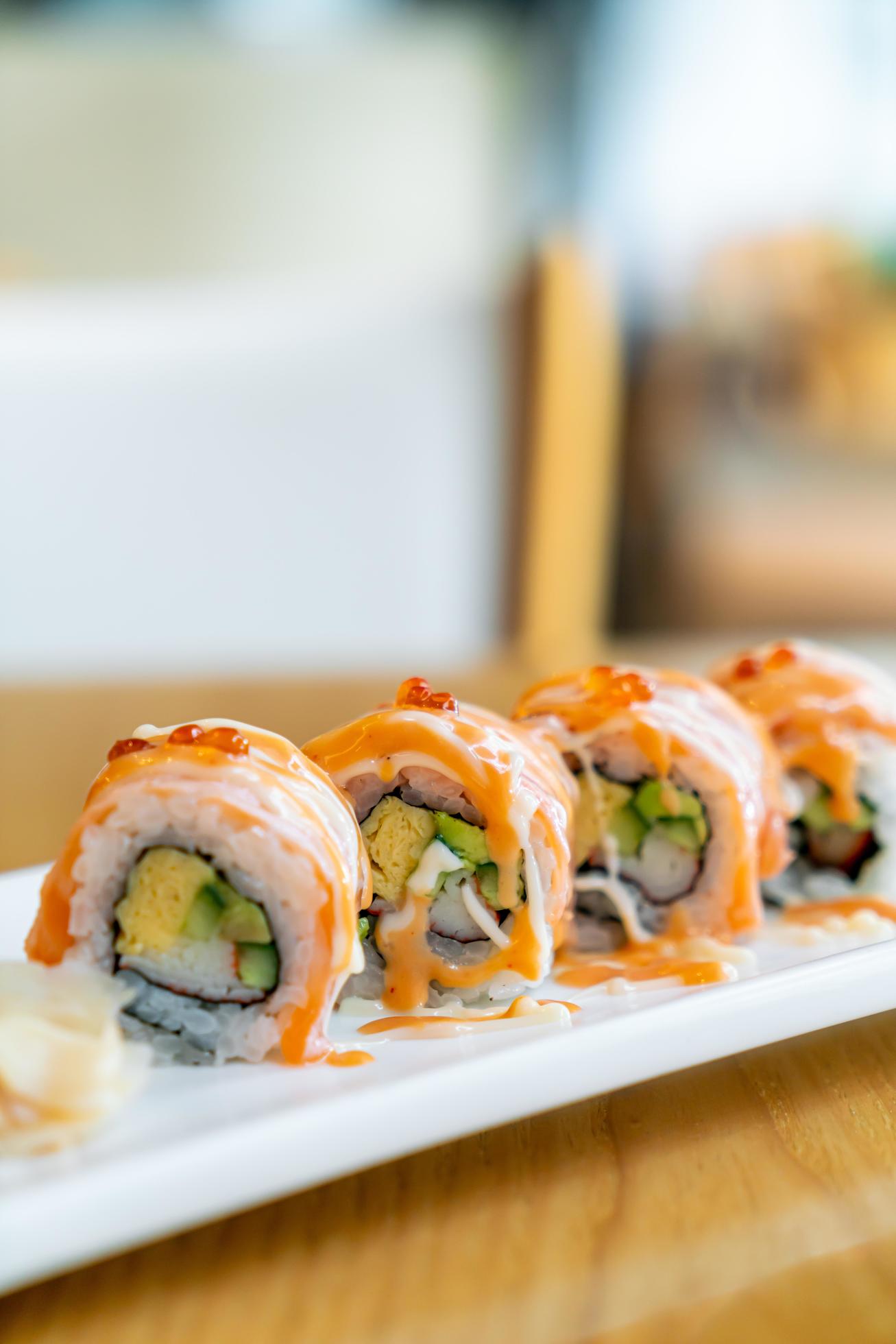 Salmon roll sushi with sauce on top – Japanese food style Stock Free