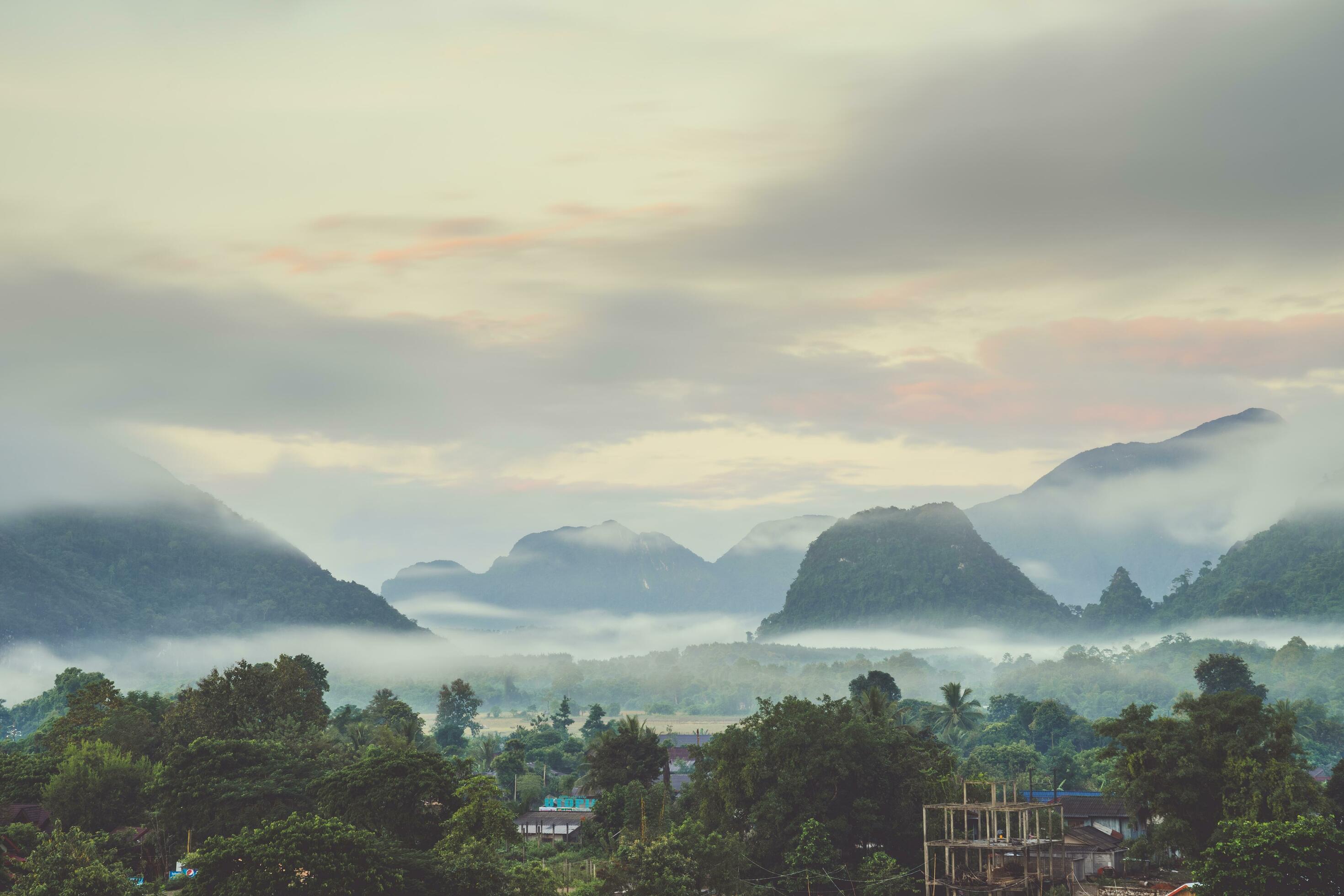 Beautiful sunrise and white mist with mountain at Vang vieng, Laos. Stock Free