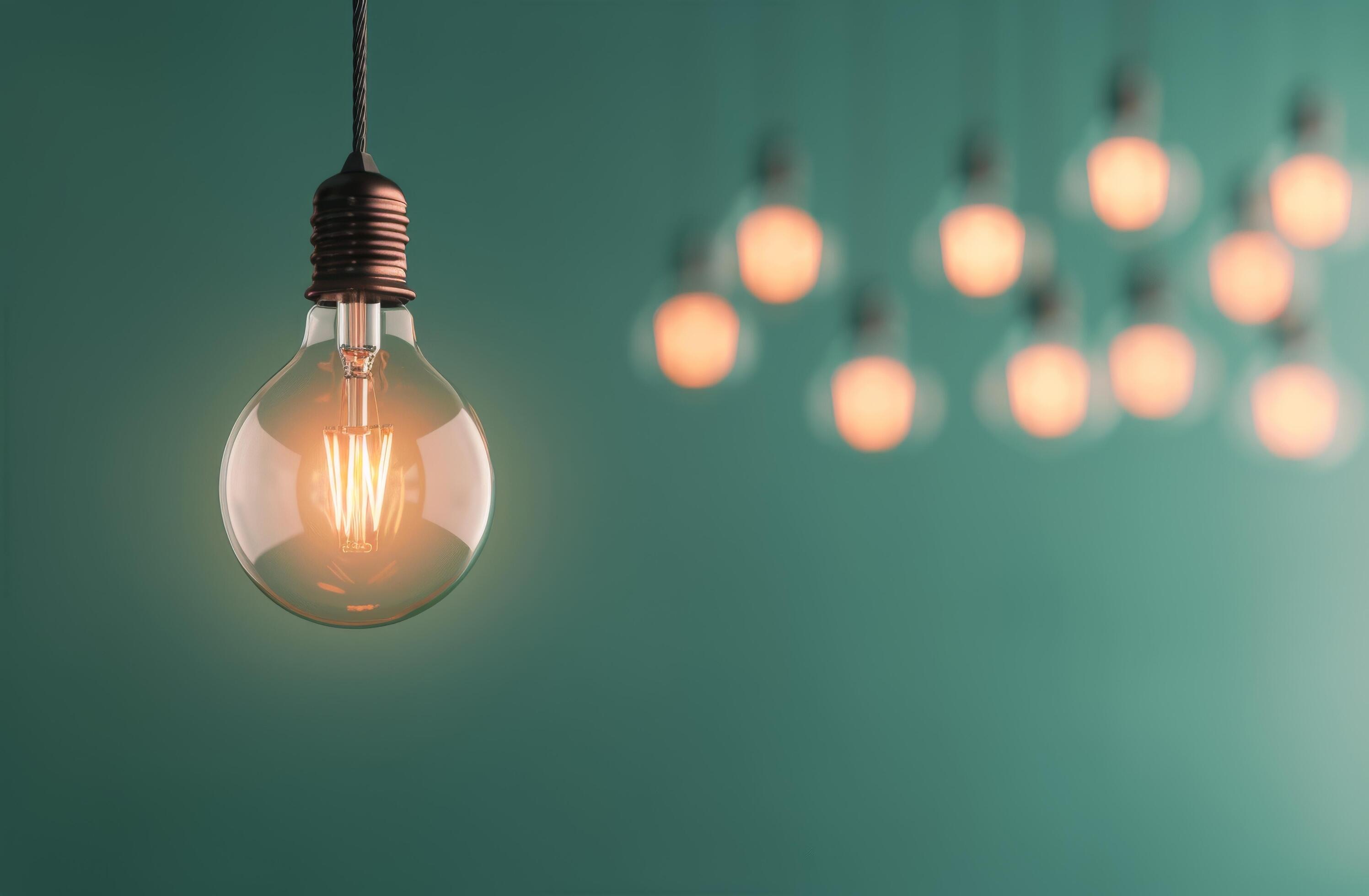 Light Bulb Hanging Against Green Background Stock Free