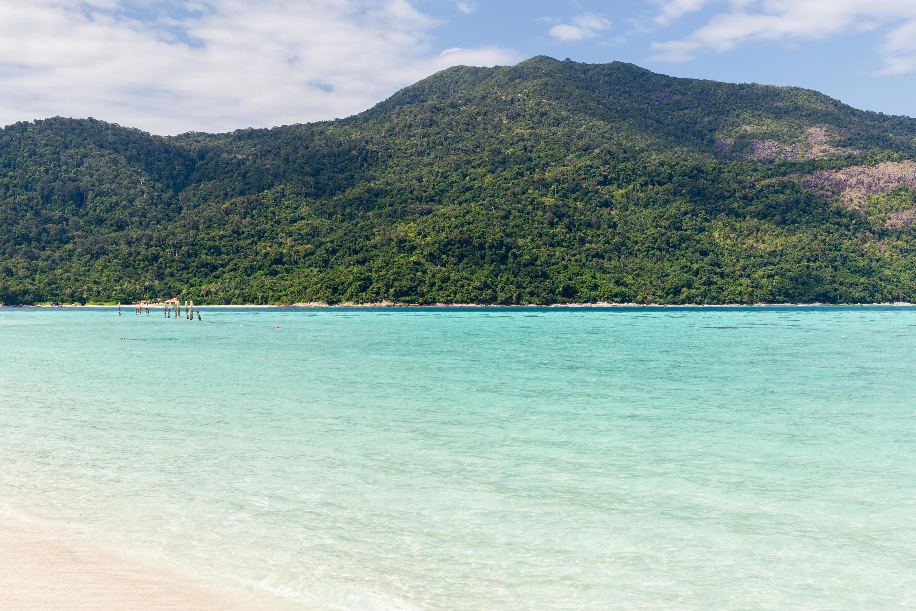 Beautiful sea with white sandy beach and blue sky in tropical island. Stock Free