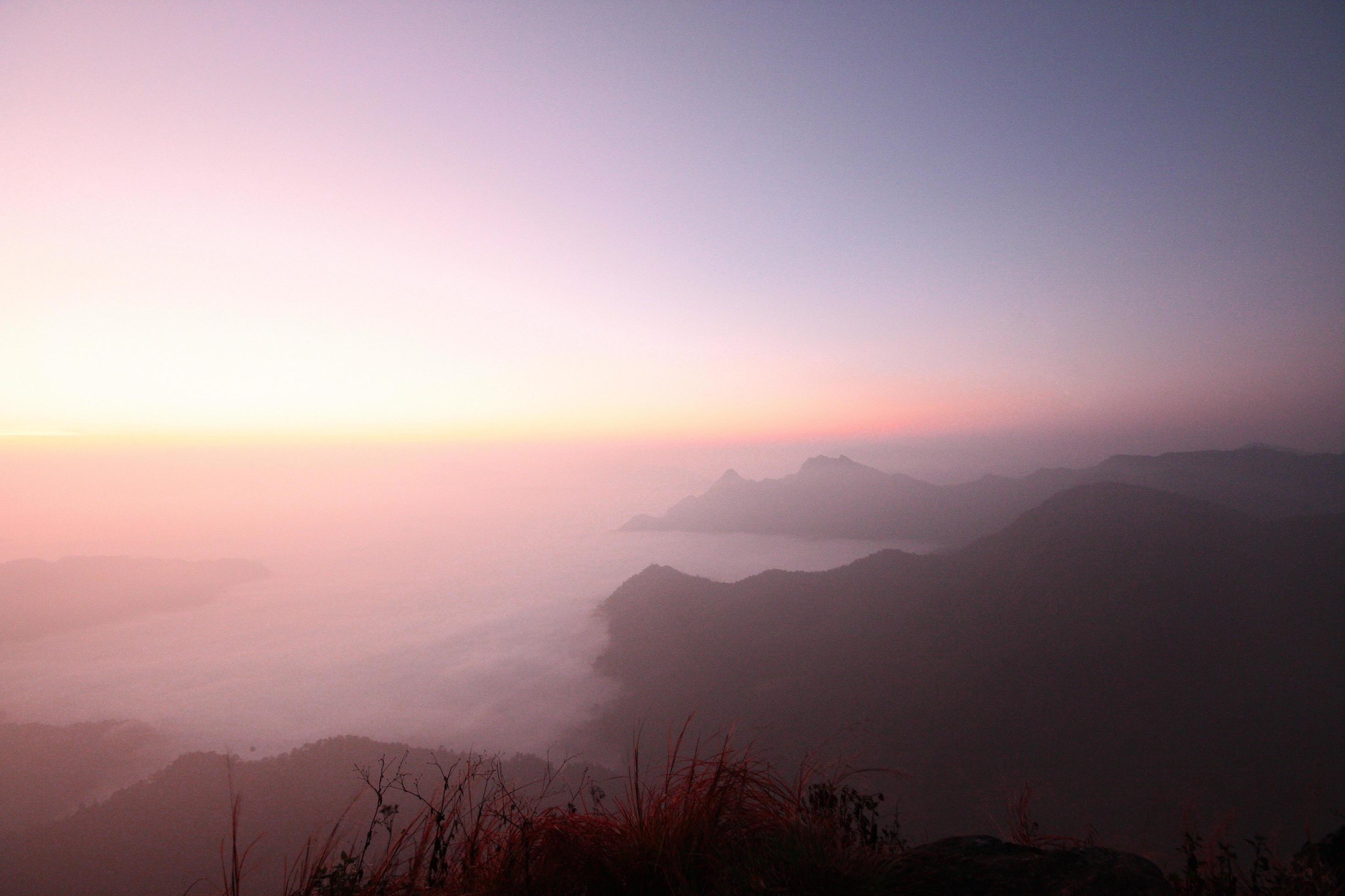 Beautiful golden natural sunlight and twiligh of sunrise shining to in the mist on valley of mountain in Thailand Stock Free