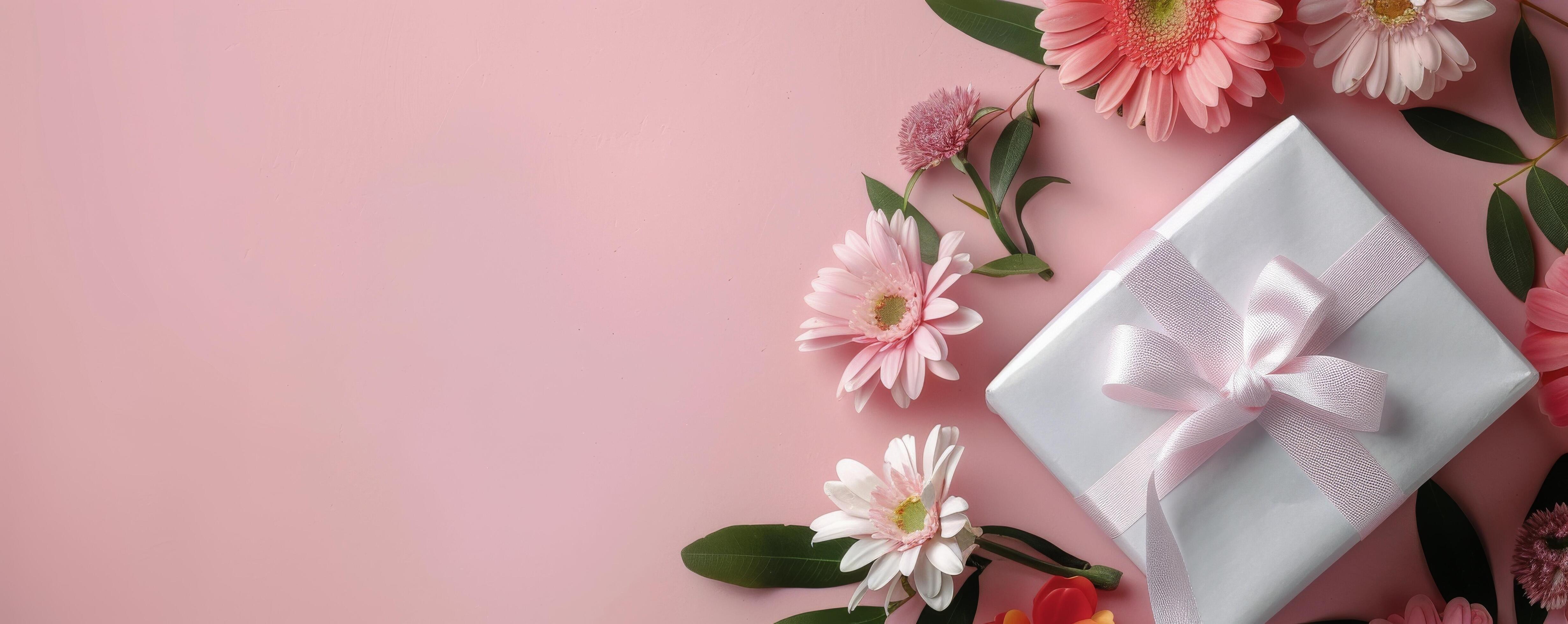 Gift Wrapped Package Surrounded by Colorful Flowers on a Pink Background Stock Free