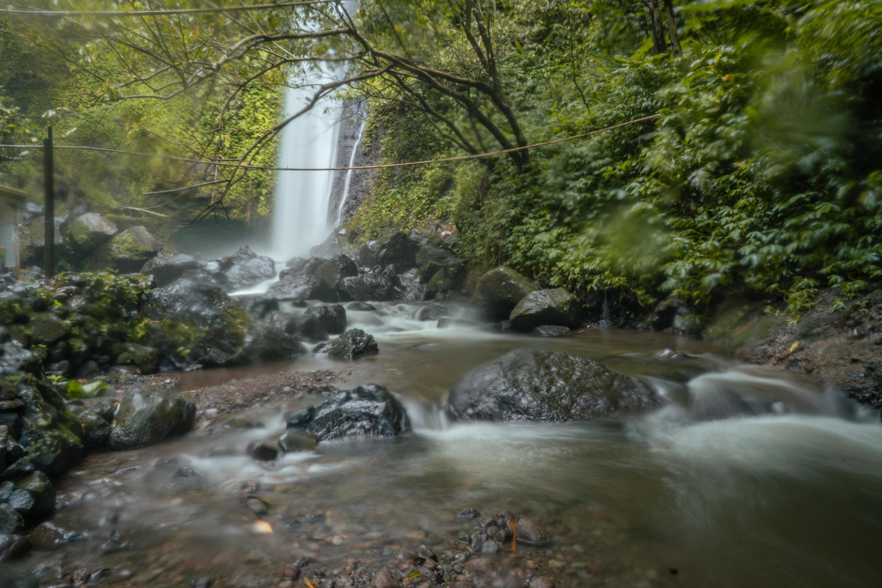 Water fall on tropical forest. Water flowing through river stone. The footage is suitable to use for nature footage, and travel destination footage. Stock Free