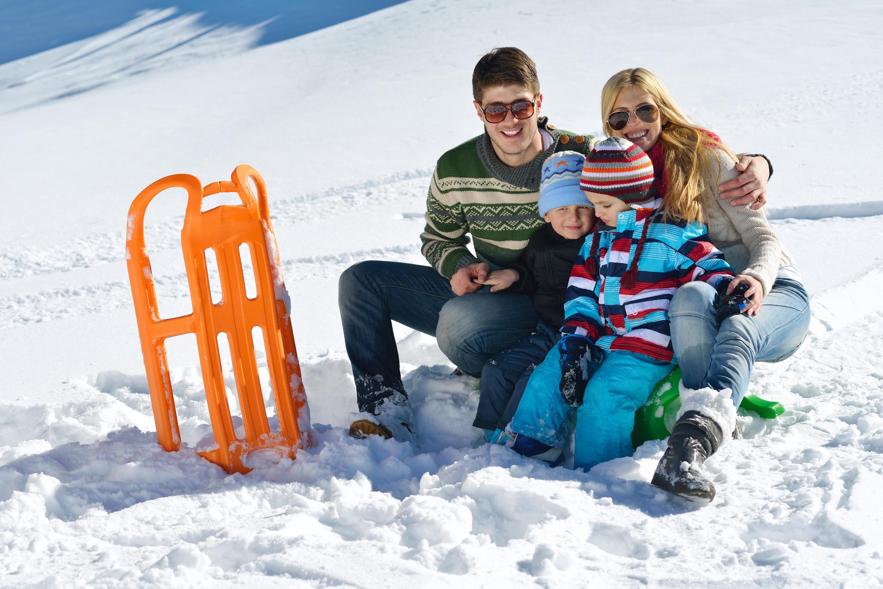 family having fun on fresh snow at winter Stock Free