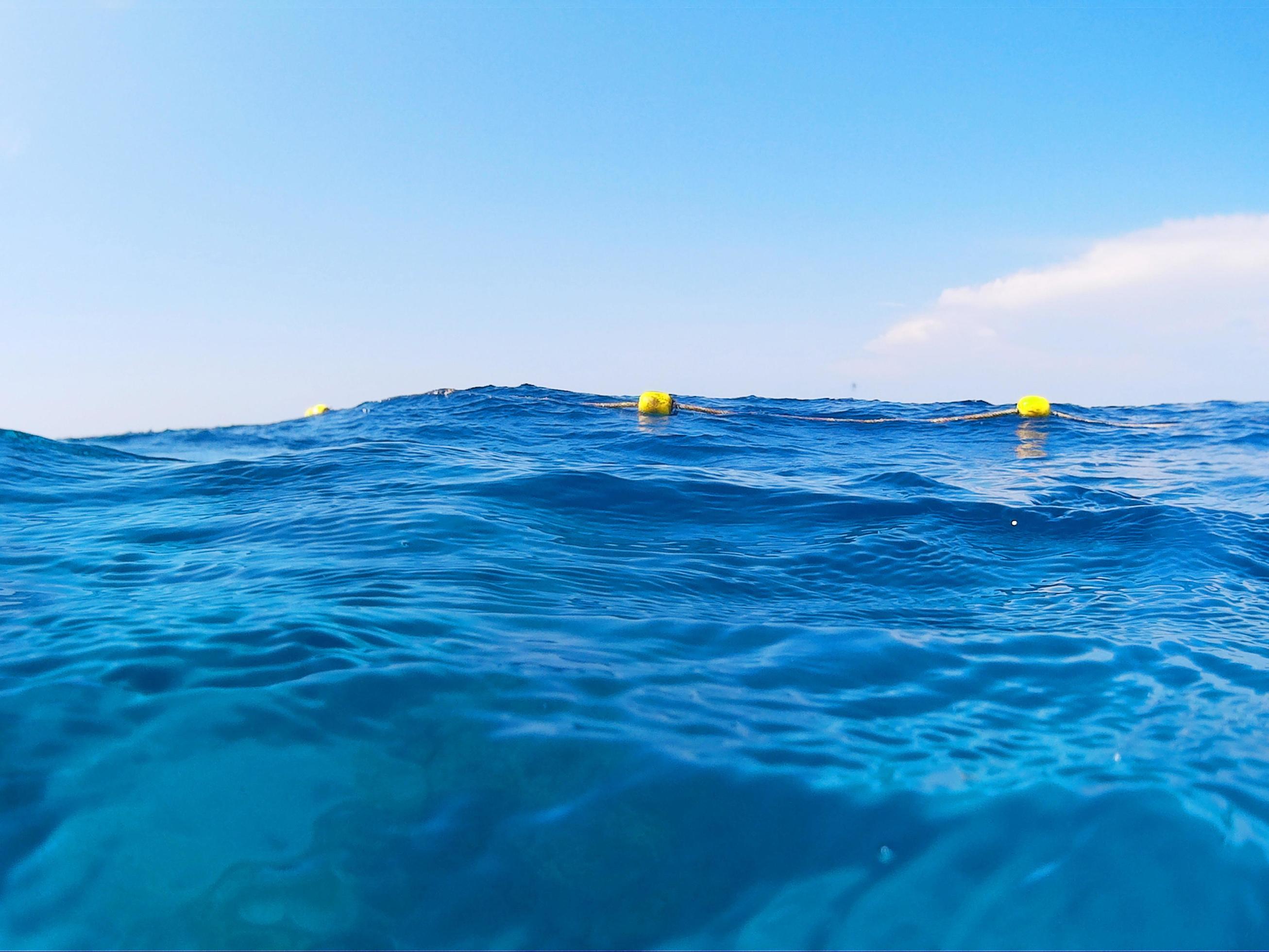 Horizon Blue sea and ocean.Seascape of calm water with waves, Water reflection and blue sky Stock Free