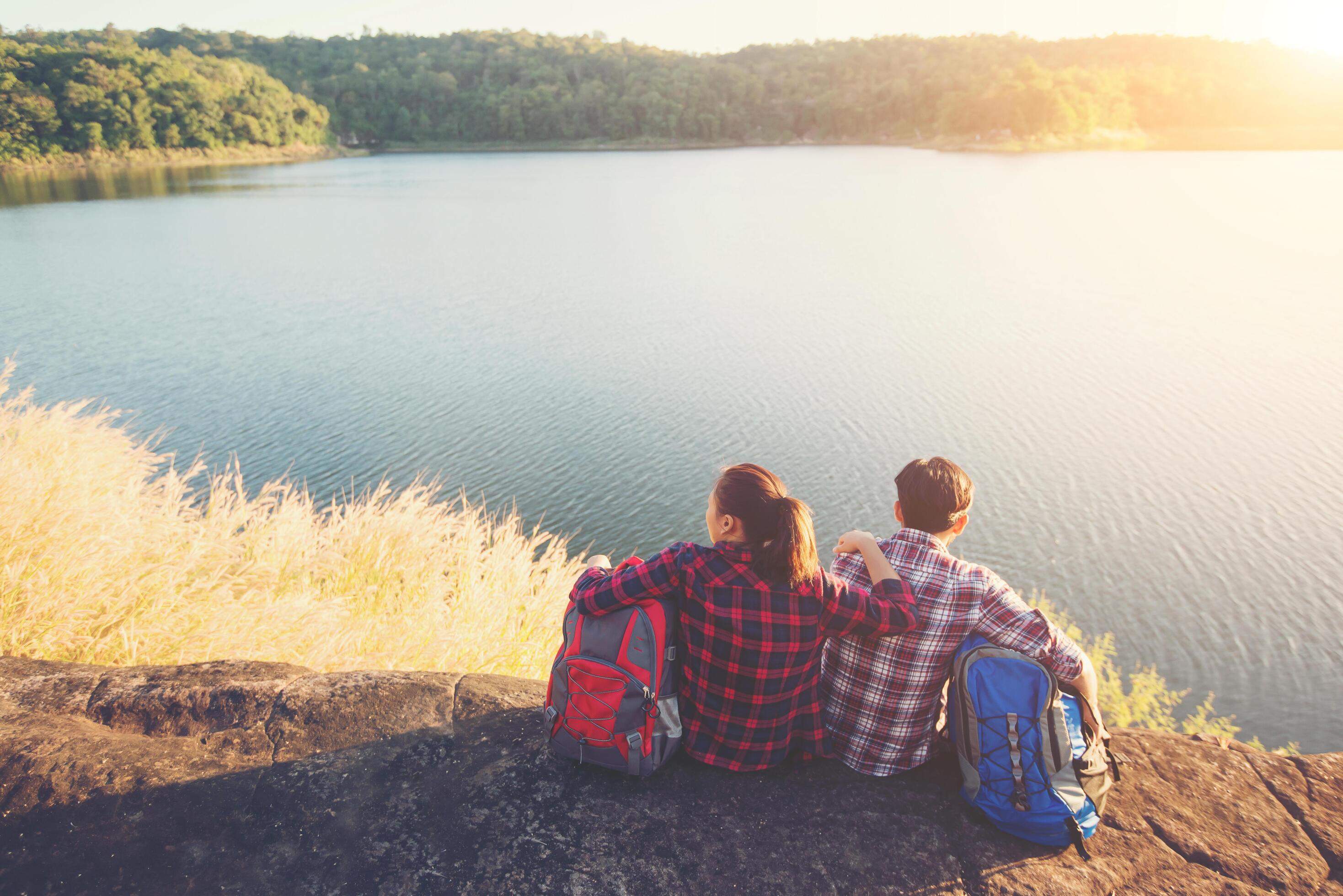 Young backpackers enjoying with nature view. Adventure lifestyle. Stock Free