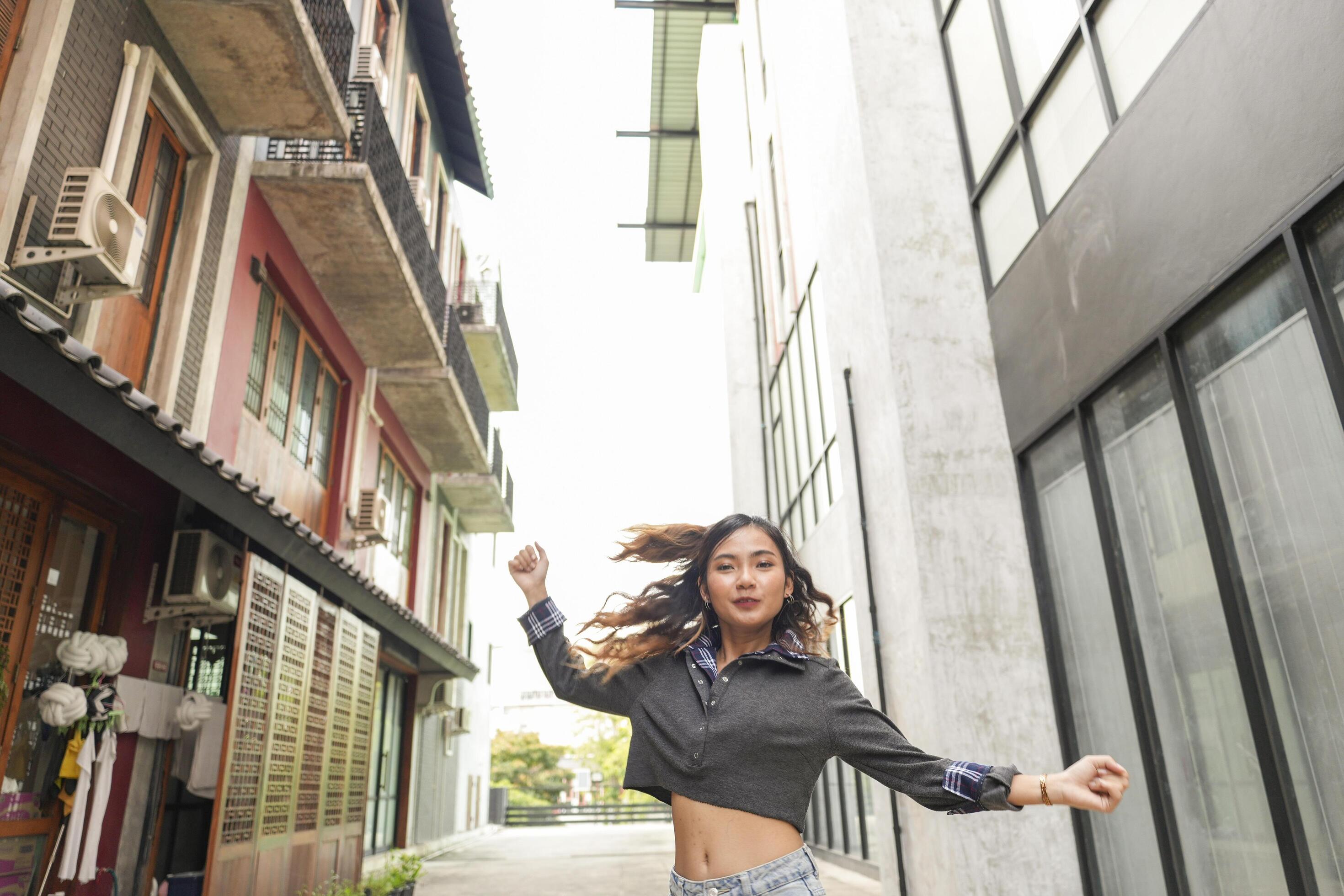 Asian women do freestyle hip hop and breakdancing in a public space in the middle of the city. With a cheerful and happy attitude Stock Free