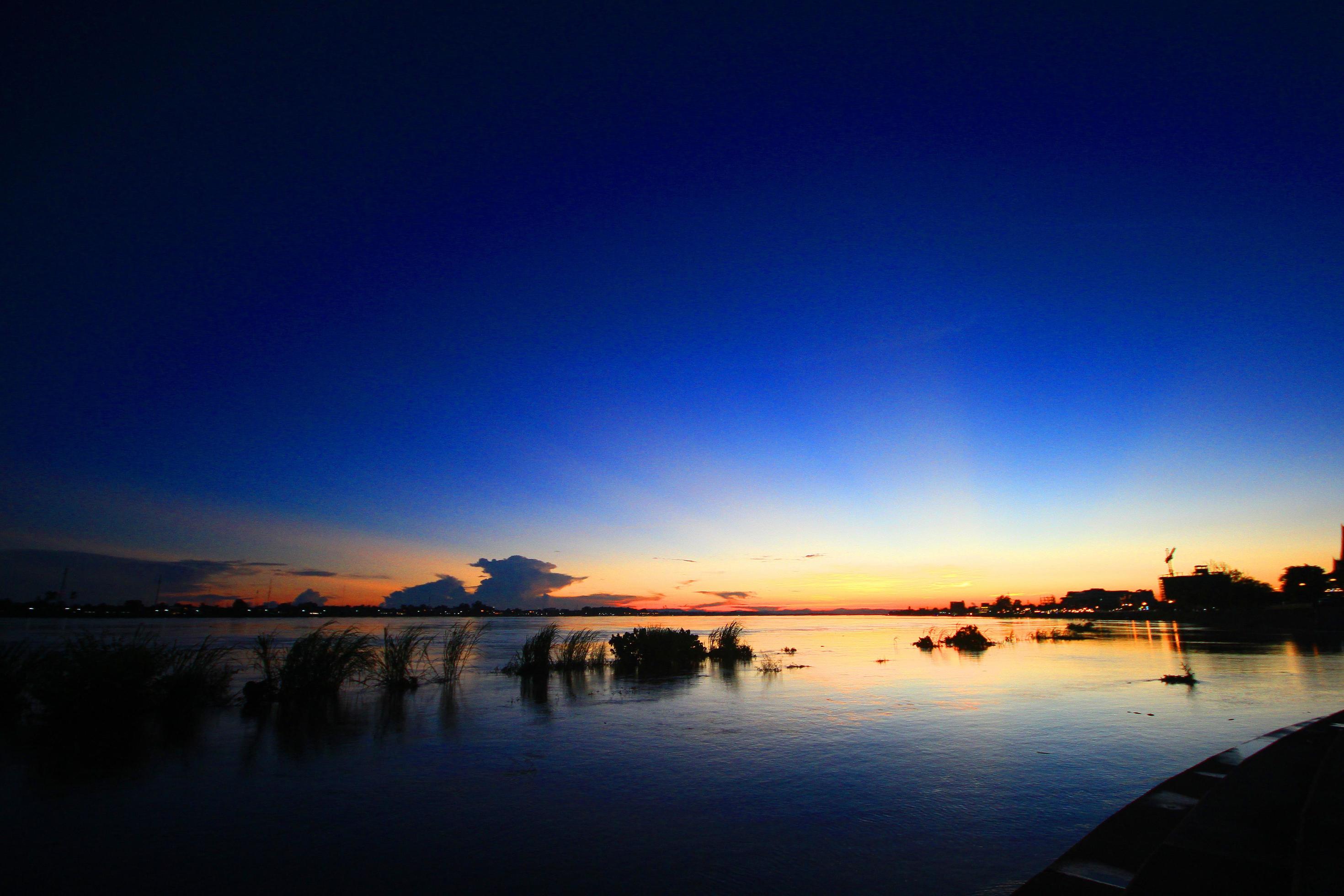 Beautiful silhouette Sunrise and sunset is twilight on the sky and reflections in the Mekong River at Vientiane Province, LAOS Stock Free