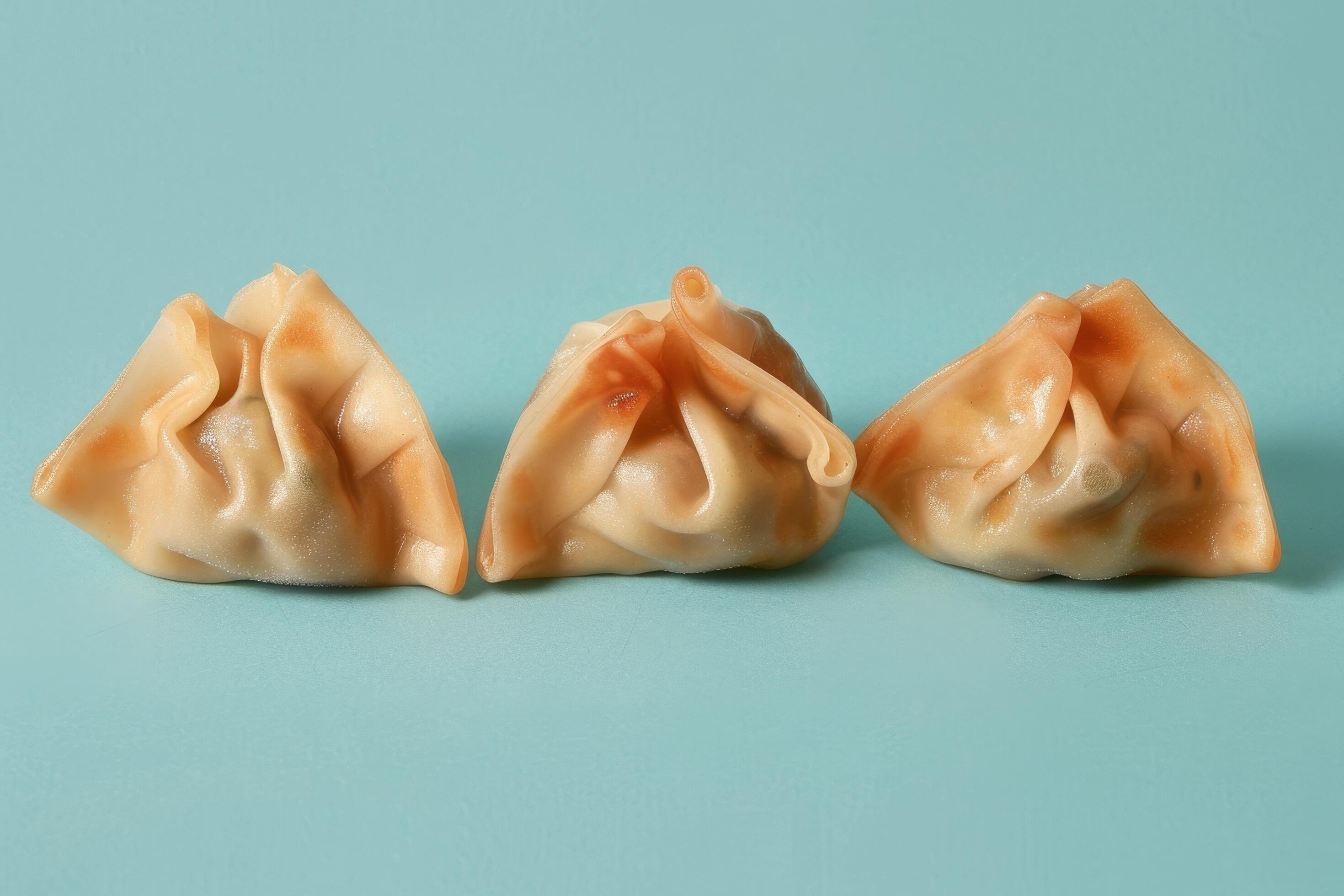 Three Steamed Dumplings on a Blue Background Stock Free