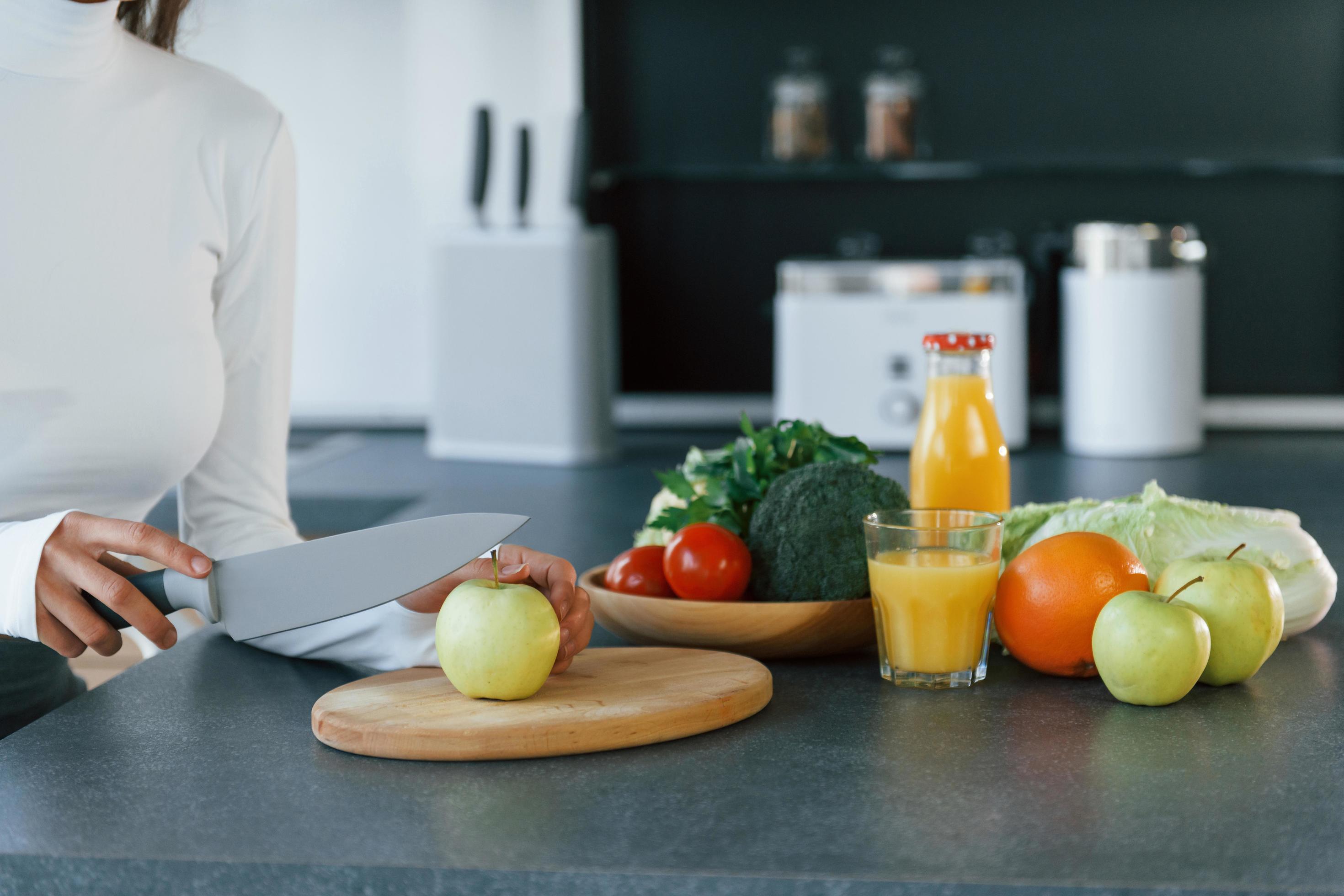 Young european woman is indoors at kitchen indoors with healthy food Stock Free