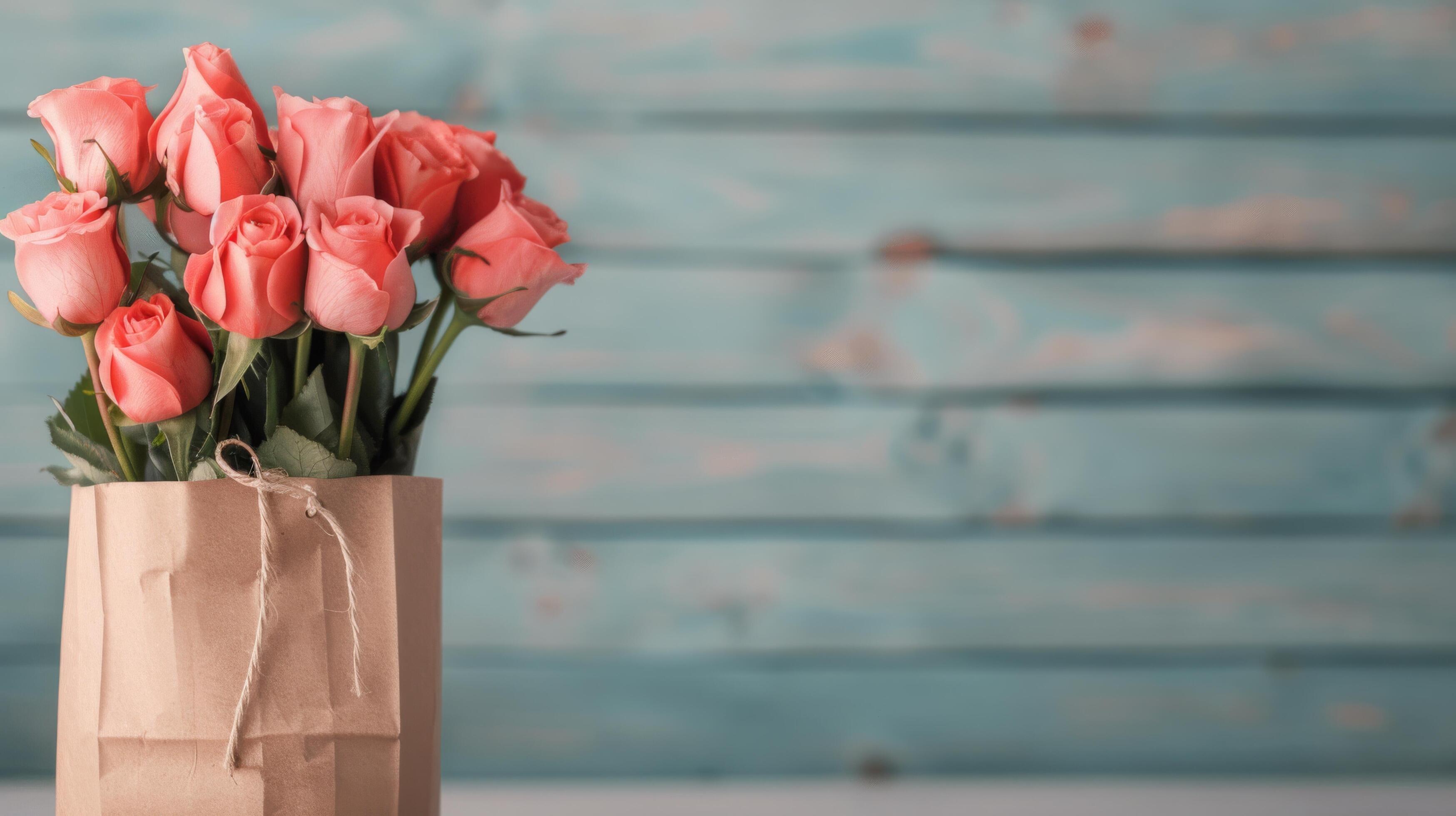 Fresh Red Roses in a Brown Paper Bag on a Soft Blurred Background Stock Free