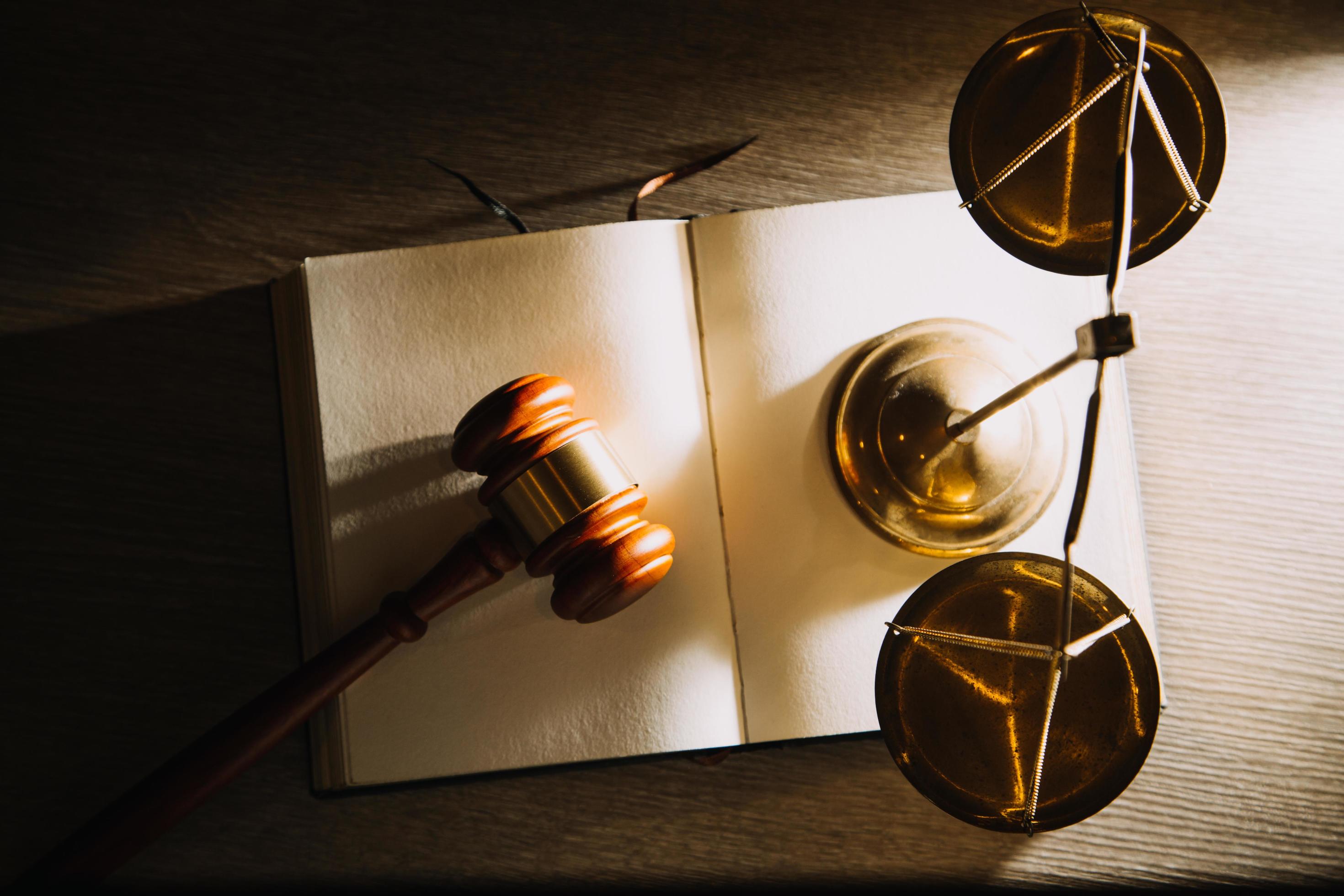 Business and lawyers discussing contract papers with brass scale on desk in office. Law, legal services, advice, justice and law concept Stock Free