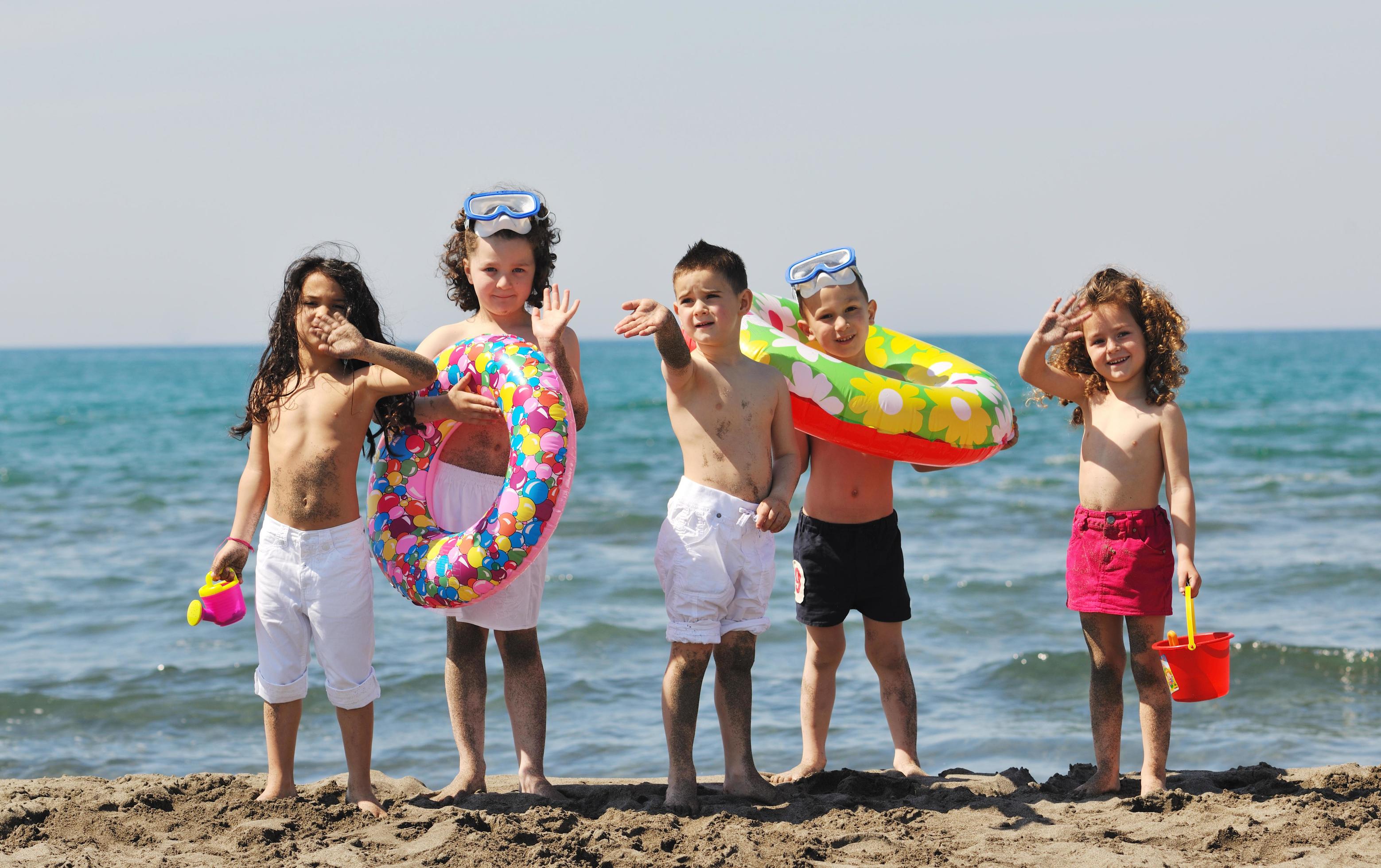 child group have fun and play with beach toys Stock Free