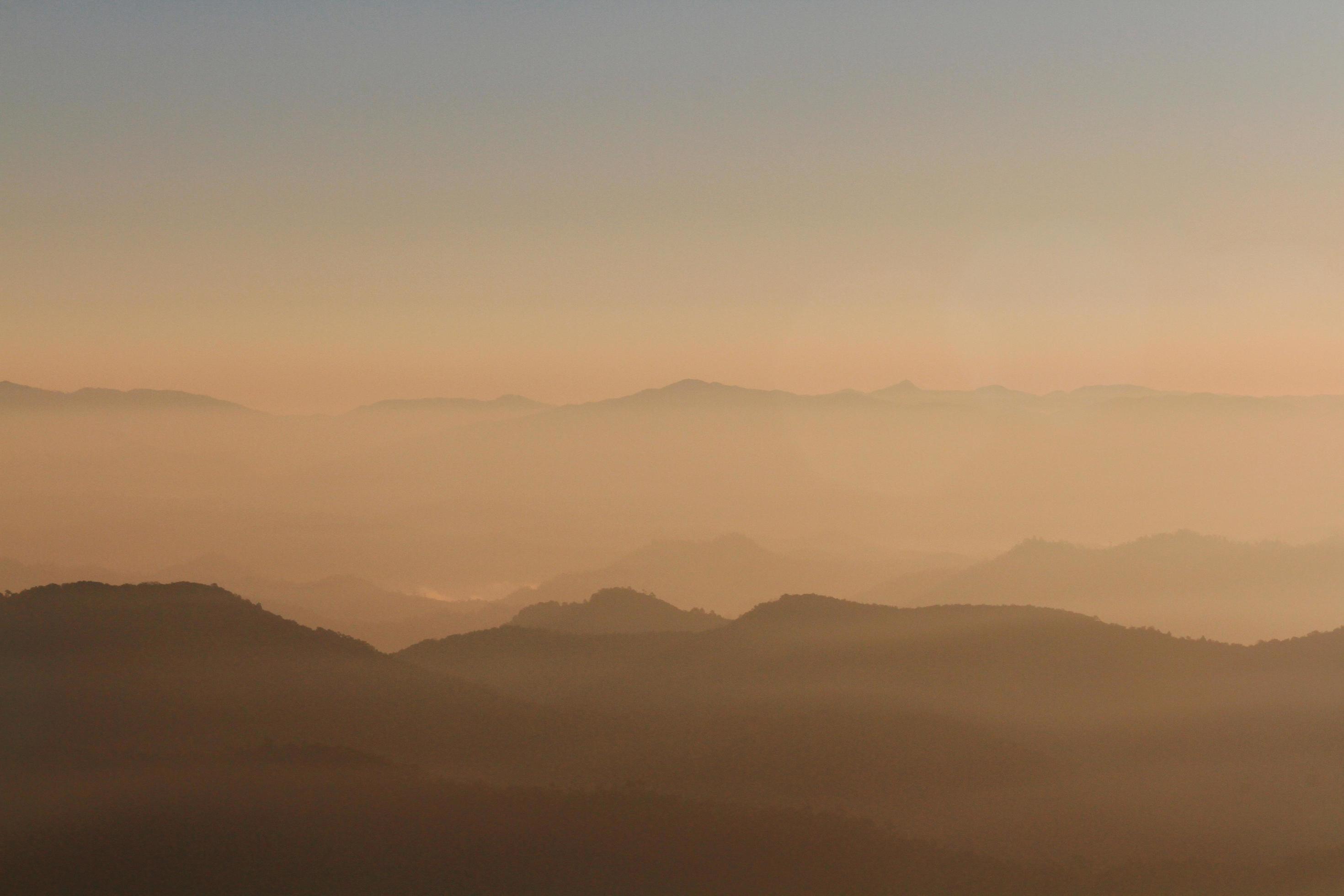 Beautiful Sunset and sunrise on sky and golden twilight time with mist and fog in valley of mountain layer Stock Free