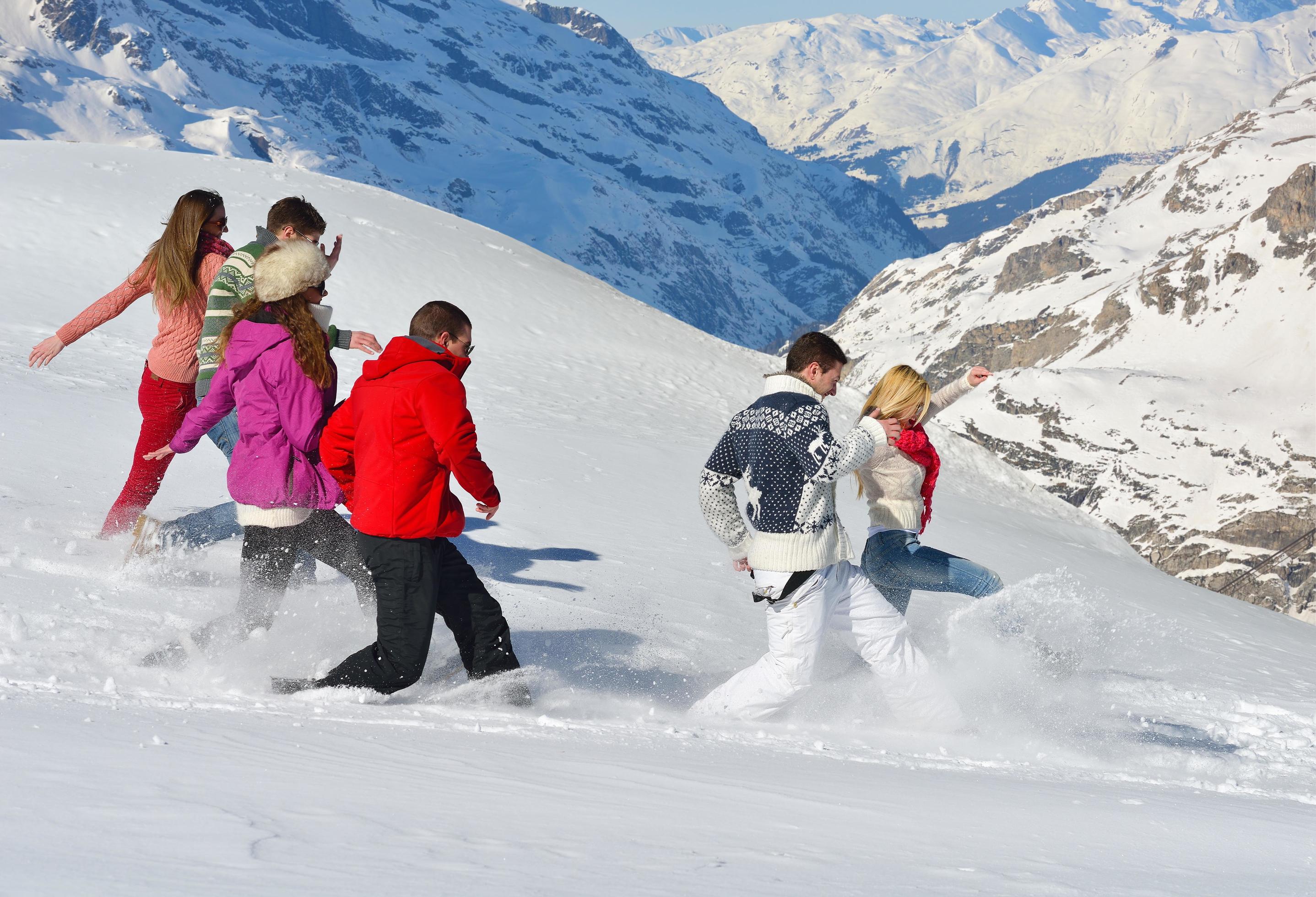 friends have fun at winter on fresh snow Stock Free