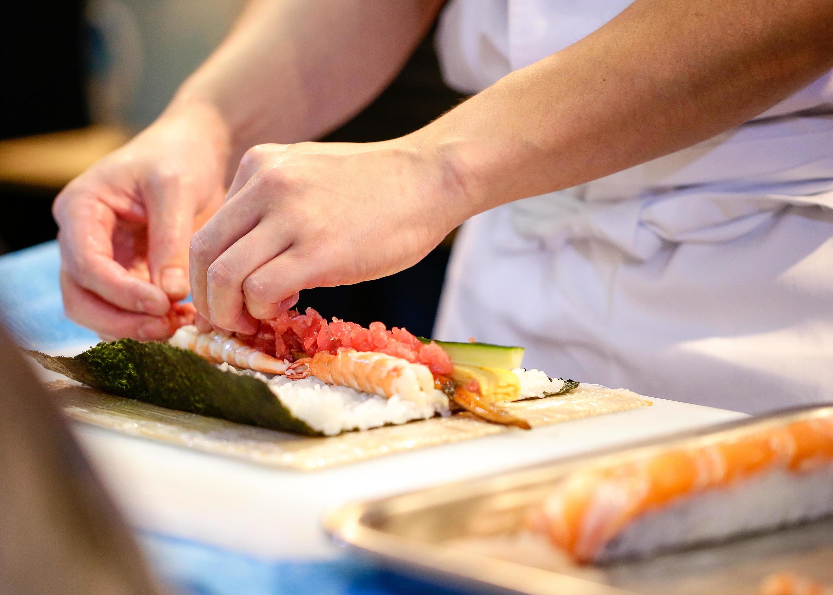 chef hands preparing japanese food, chef making sushi Stock Free