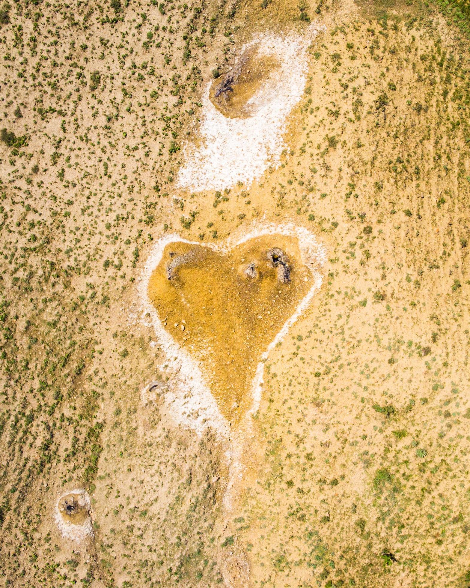 Top down view orange heart shape form on mud volcanoes site in chachuna nature reserve, VAshlovani national park, Georgia Stock Free