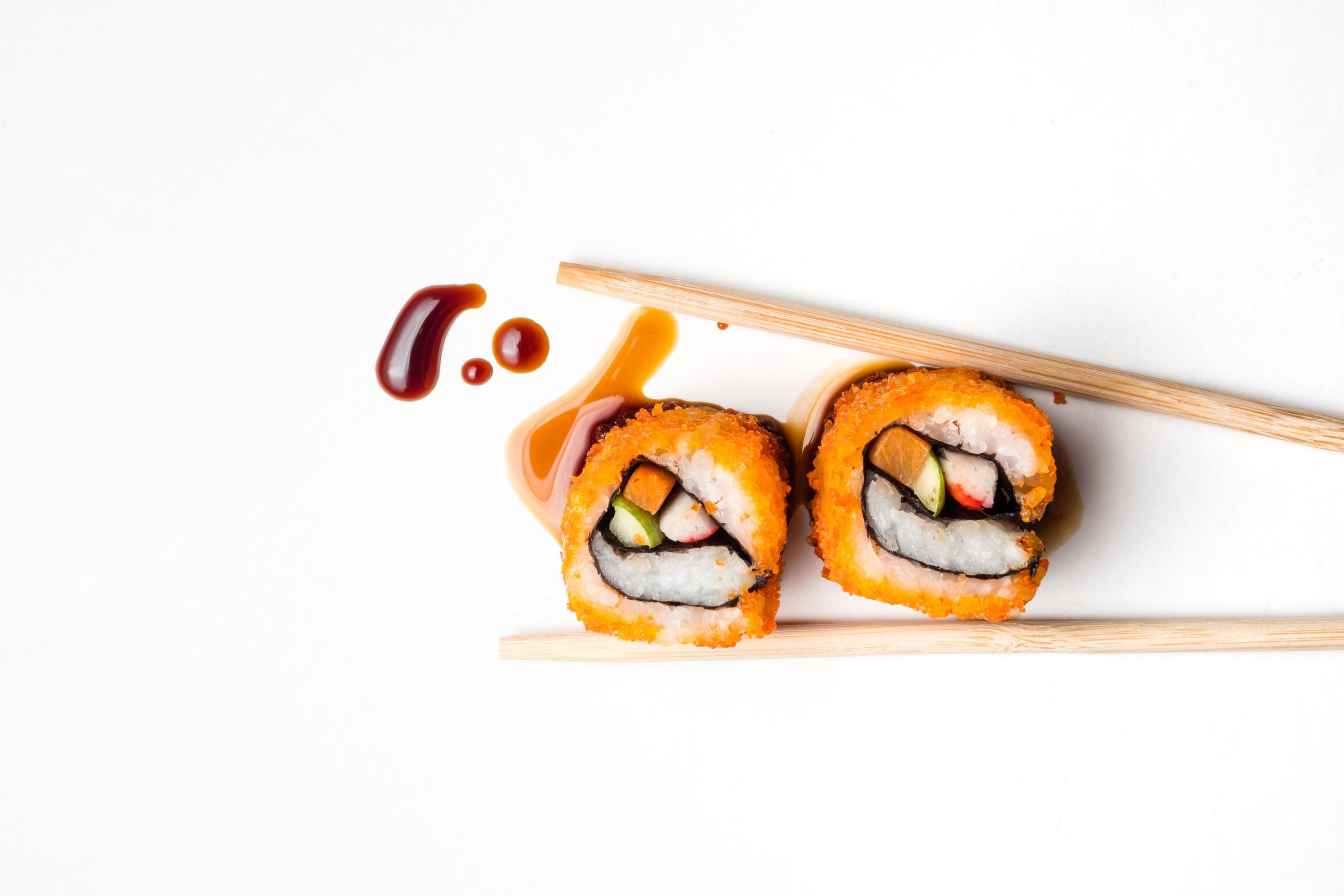 Sushi, japanese food, california roll with chopsticks and sauce on white background. Stock Free