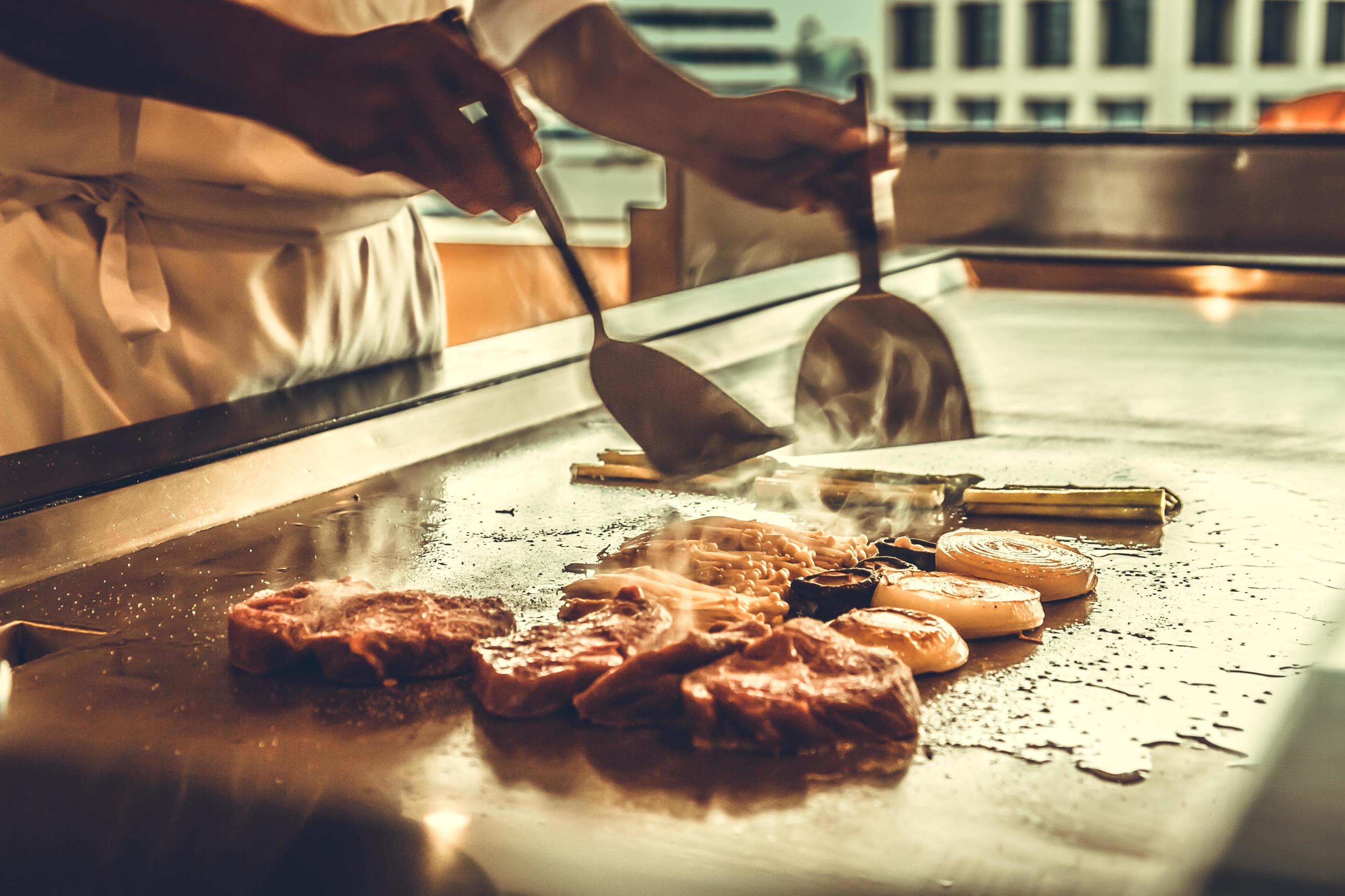 Close up hands chef cooking beef steak and vegetable on hot pan, Japanese food Stock Free