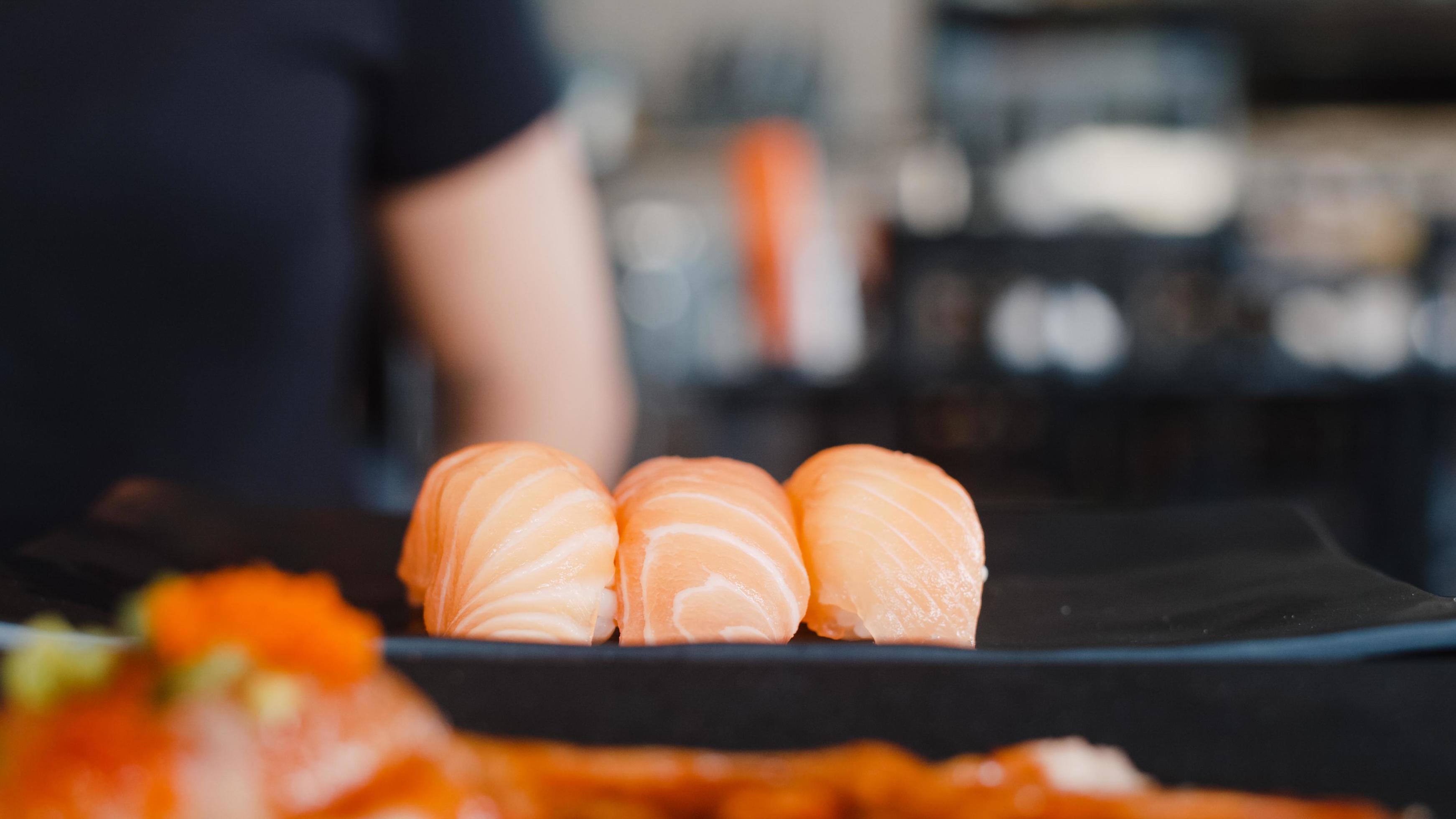 Japanese salmon sushi on plate in Japanese restaurant. Asian Japan traditional food fresh and delicious ingredients. Stock Free