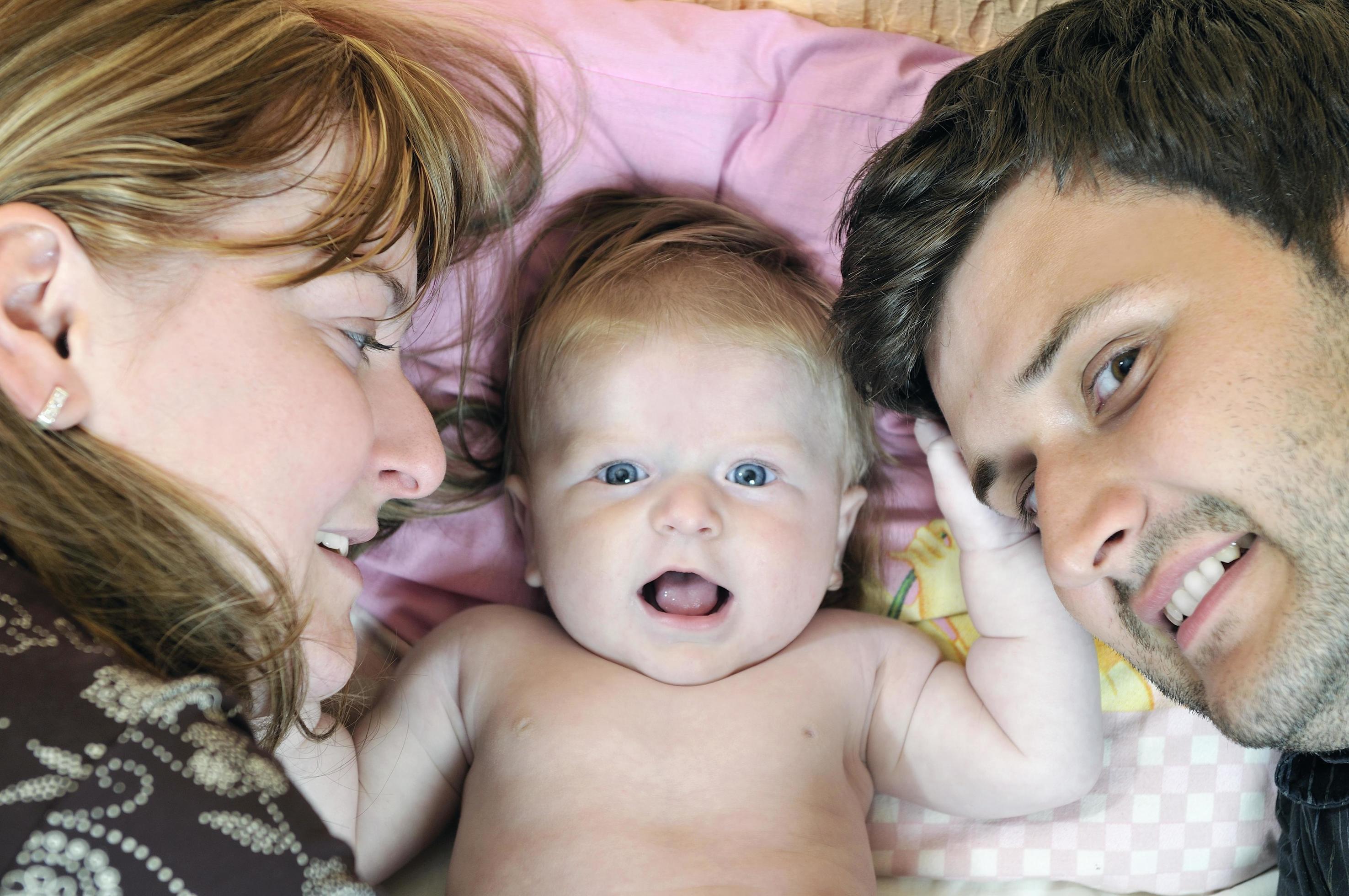 portrait of young family with cute little babby Stock Free